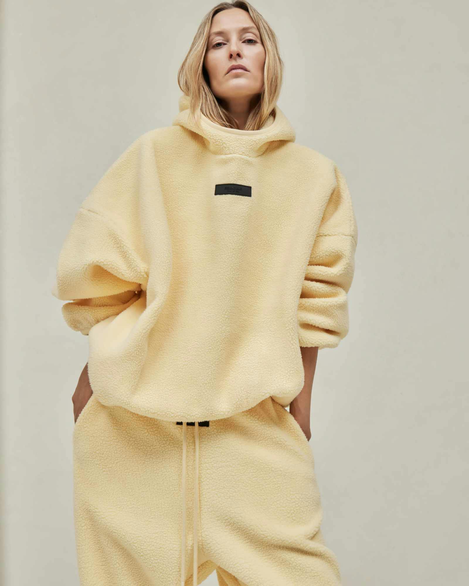 Models wear Fear of God ESSENTIALS' Winter 2023 hoodies, sweatshirts, t-shirts, and sweatpants