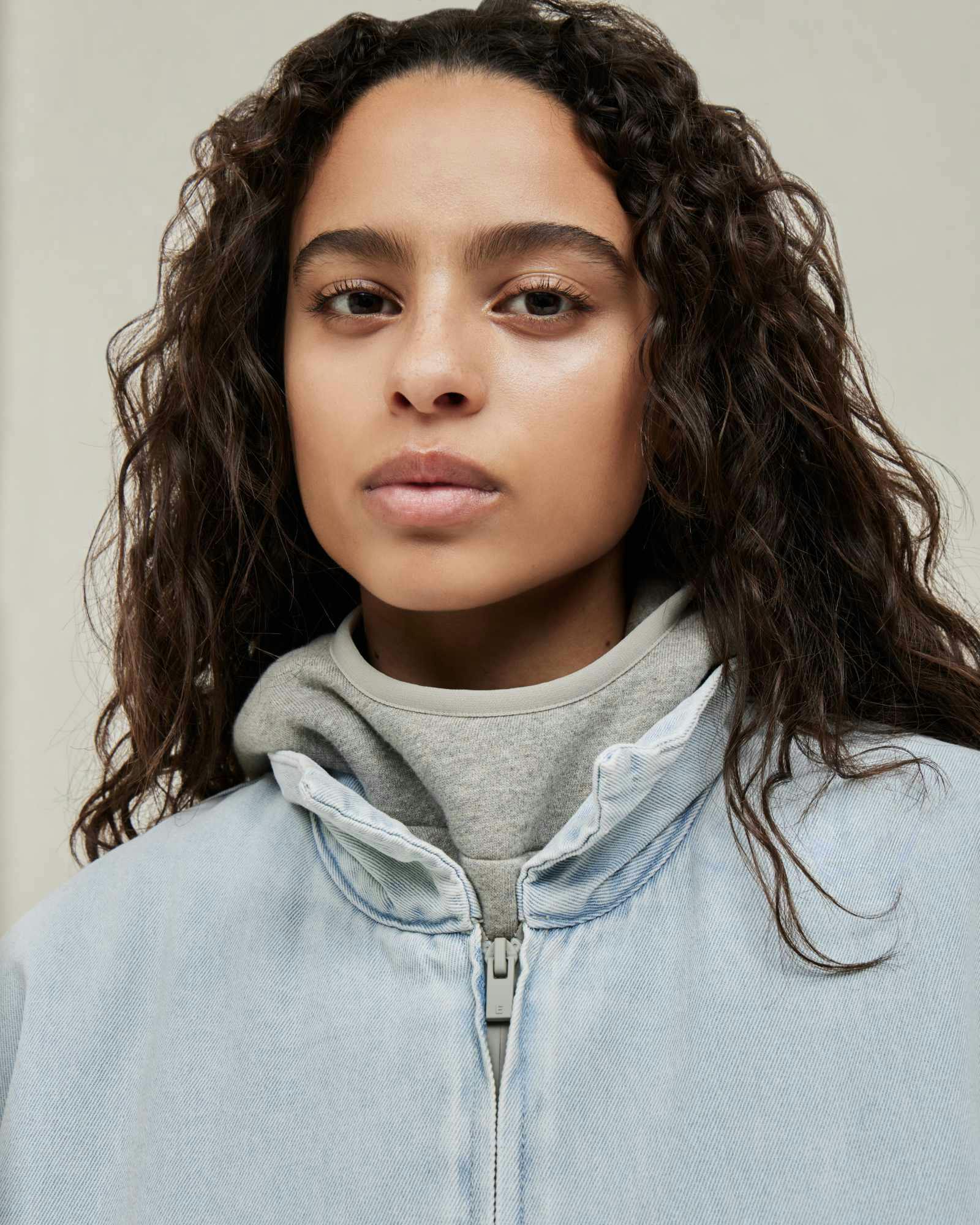 Models wear Fear of God ESSENTIALS' Winter 2023 hoodies, sweatshirts, t-shirts, and sweatpants