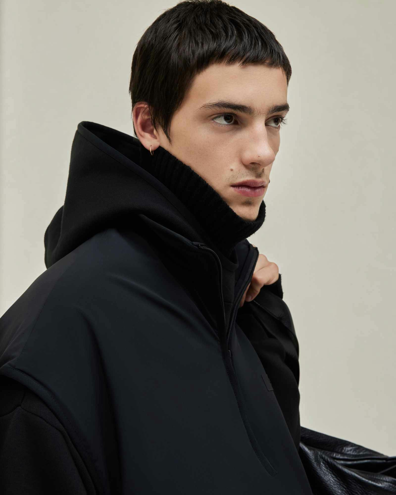 Models wear Fear of God ESSENTIALS' Winter 2023 hoodies, sweatshirts, t-shirts, and sweatpants