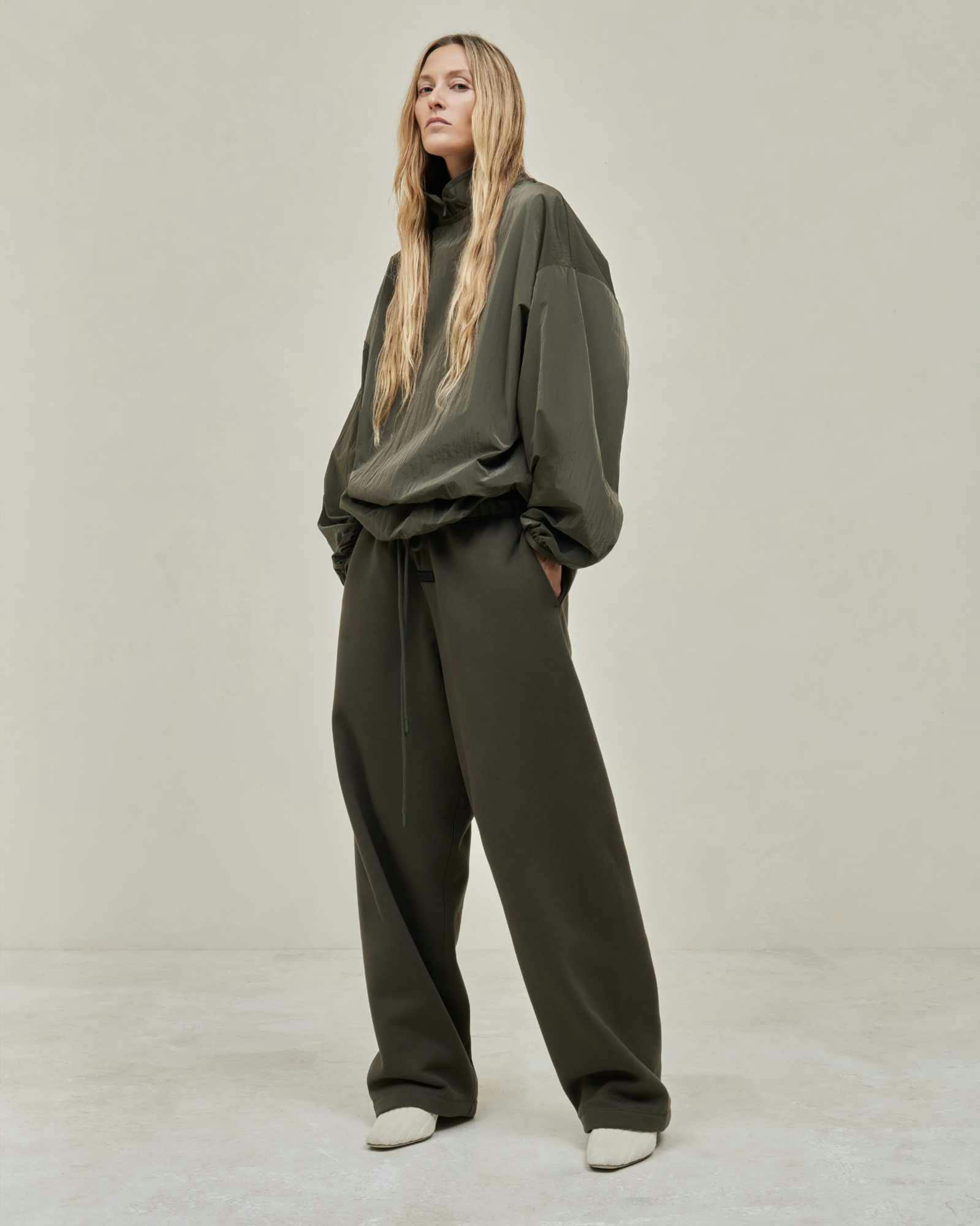 Models wear Fear of God ESSENTIALS' Winter 2023 hoodies, sweatshirts, t-shirts, and sweatpants