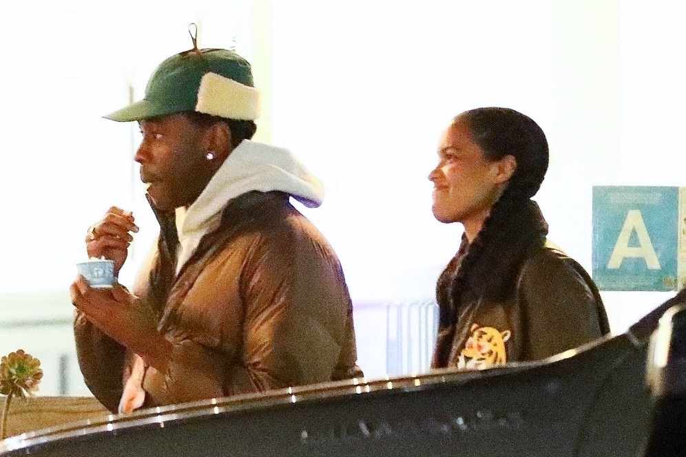 Tyler the Creator & a woman out on a date in December 2023, wearing a fur trapper hat and Louis Vuitton jacket