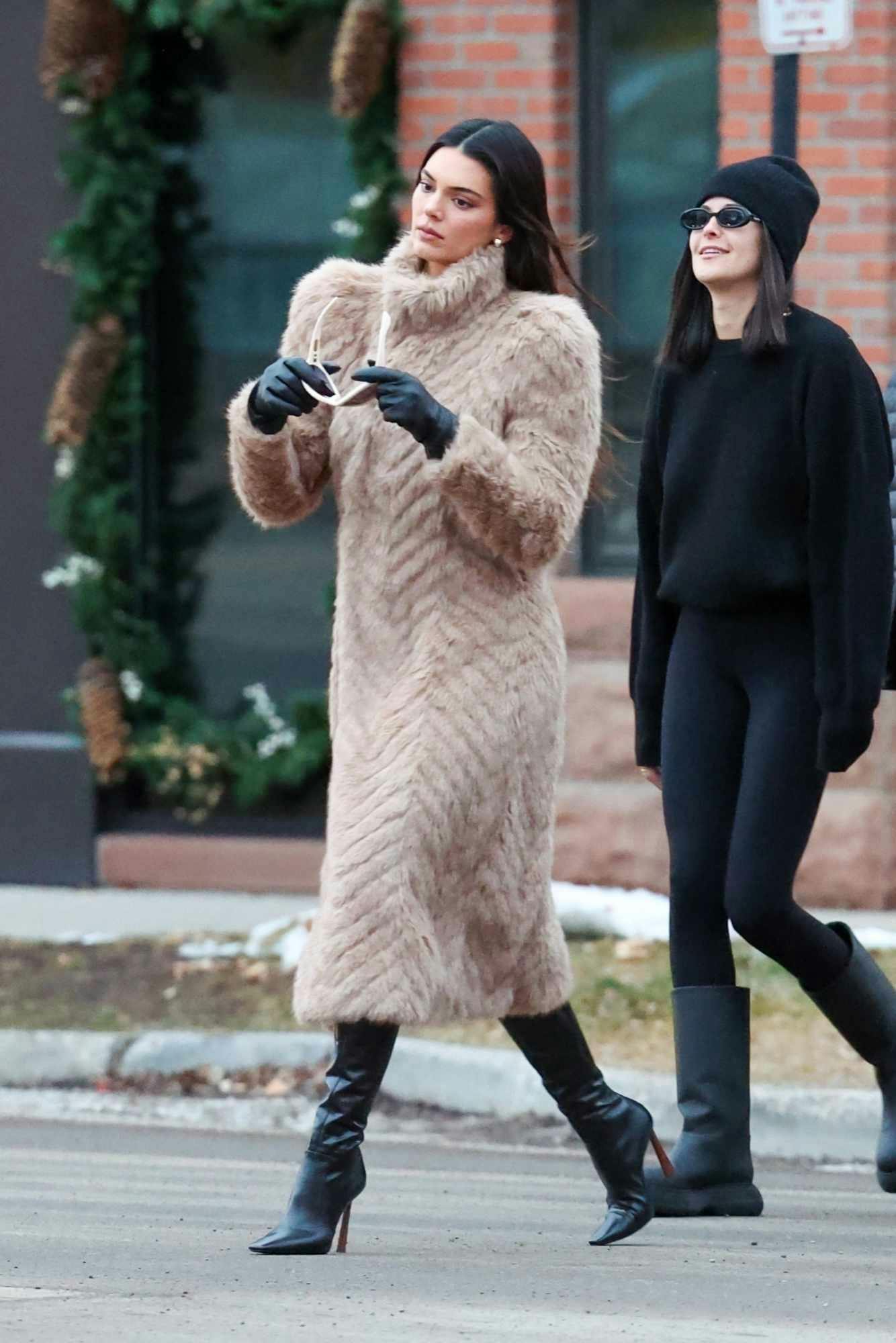 Kendall Jenner wears a Balenciaga fur coat, GIA BORGHINI boots & MEGA earrings in Aspen