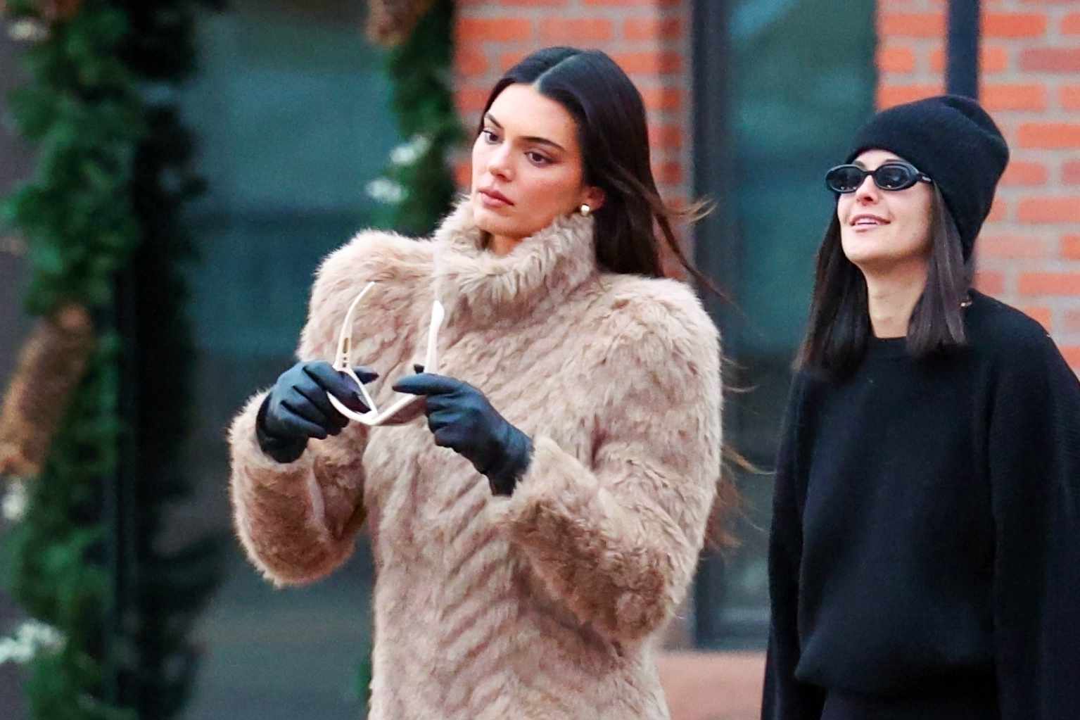 Kendall Jenner wears a Balenciaga fur coat, GIA BORGHINI boots & MEGA earrings in Aspen