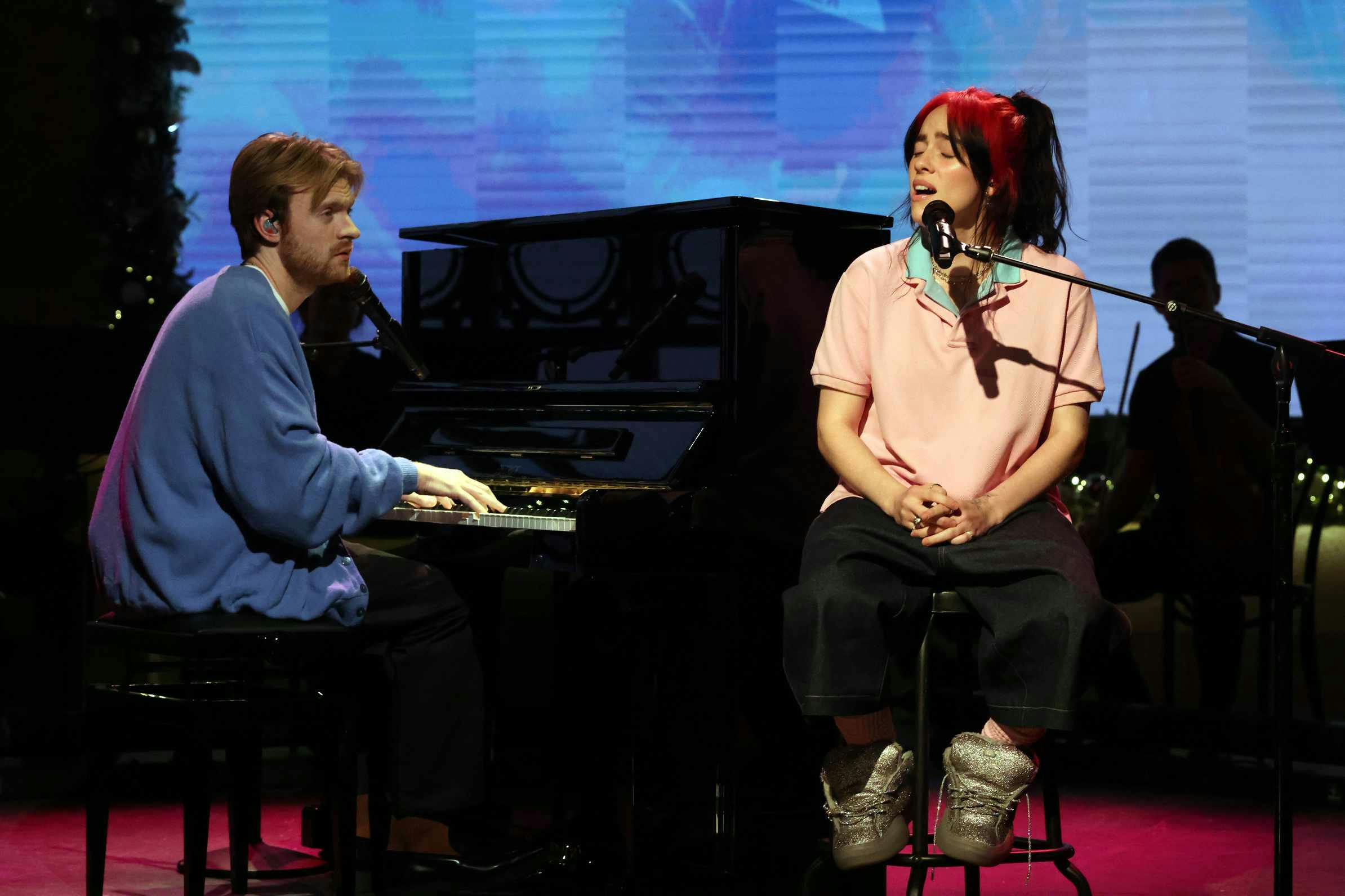 Billie Eilish wearing a Raimundo Langlois polo shirt and ERL sneakers on Saturday Night Live