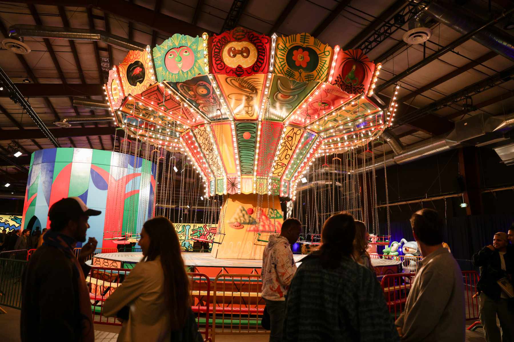 Attendees walk through Luna Luna art amusement park in December 2023