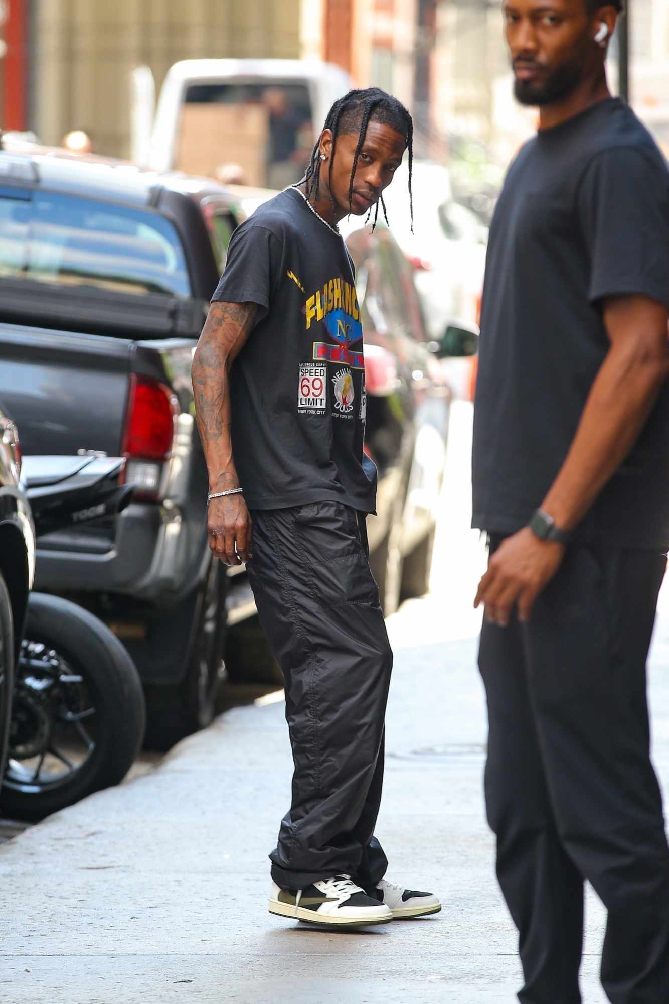 Travis Scott seen in New York wearing a grey Flashdancers T-shirt, black pants & his Cactus Jack Air Jordan 1