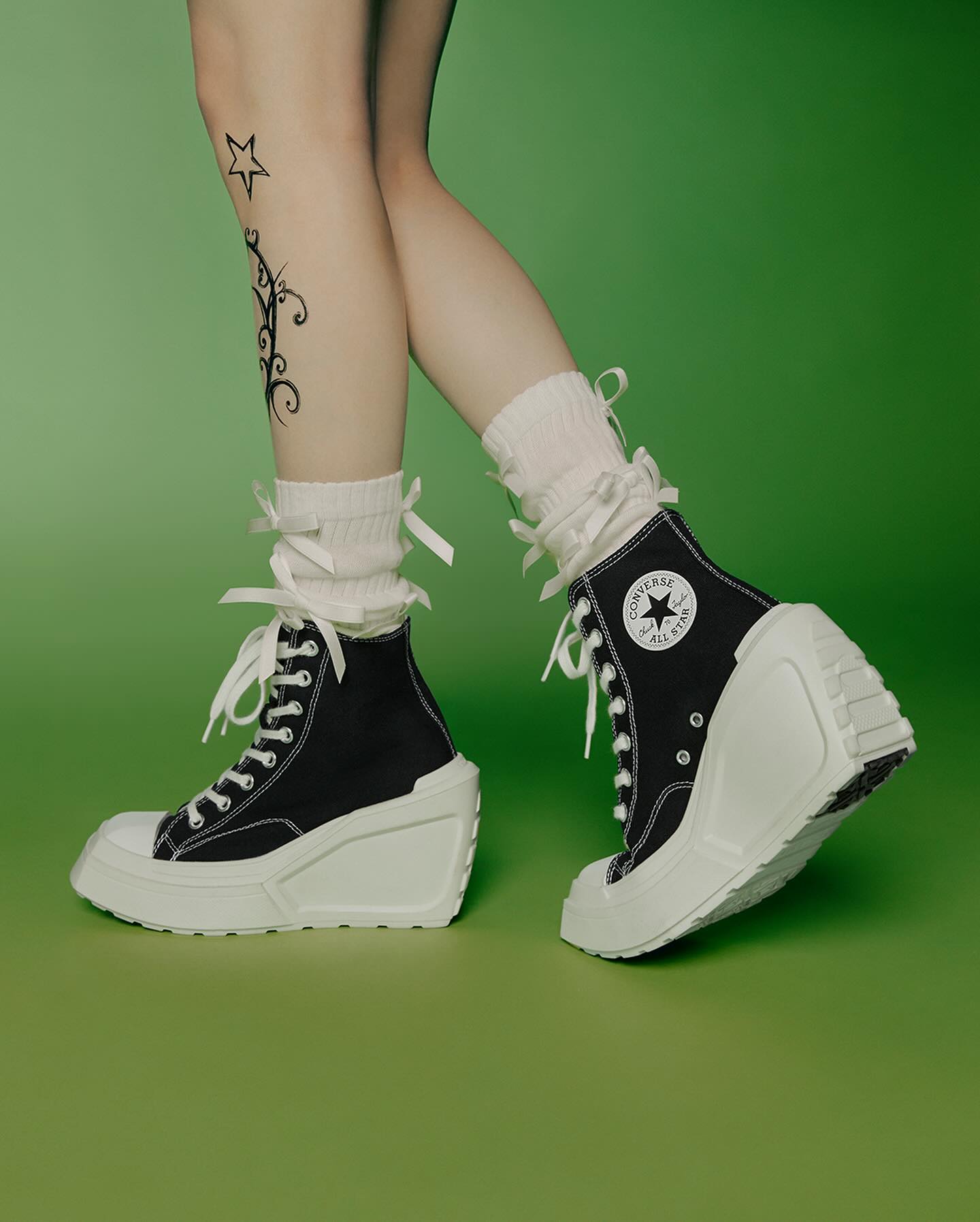 Converse's de luxe wedge heel sneaker in black and white worn by AESPA member Karina