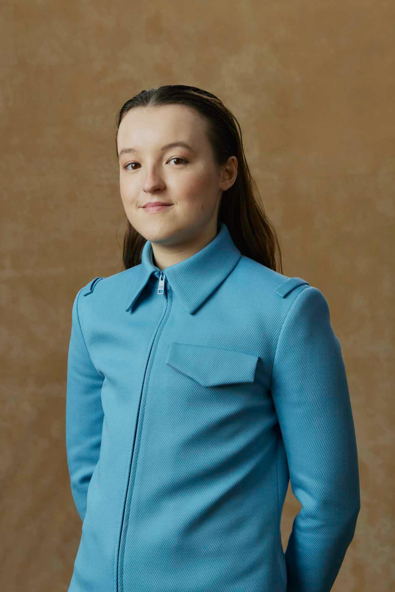 Bella Ramsey wears a blue Prada shirt at the 2024 Golden Globes