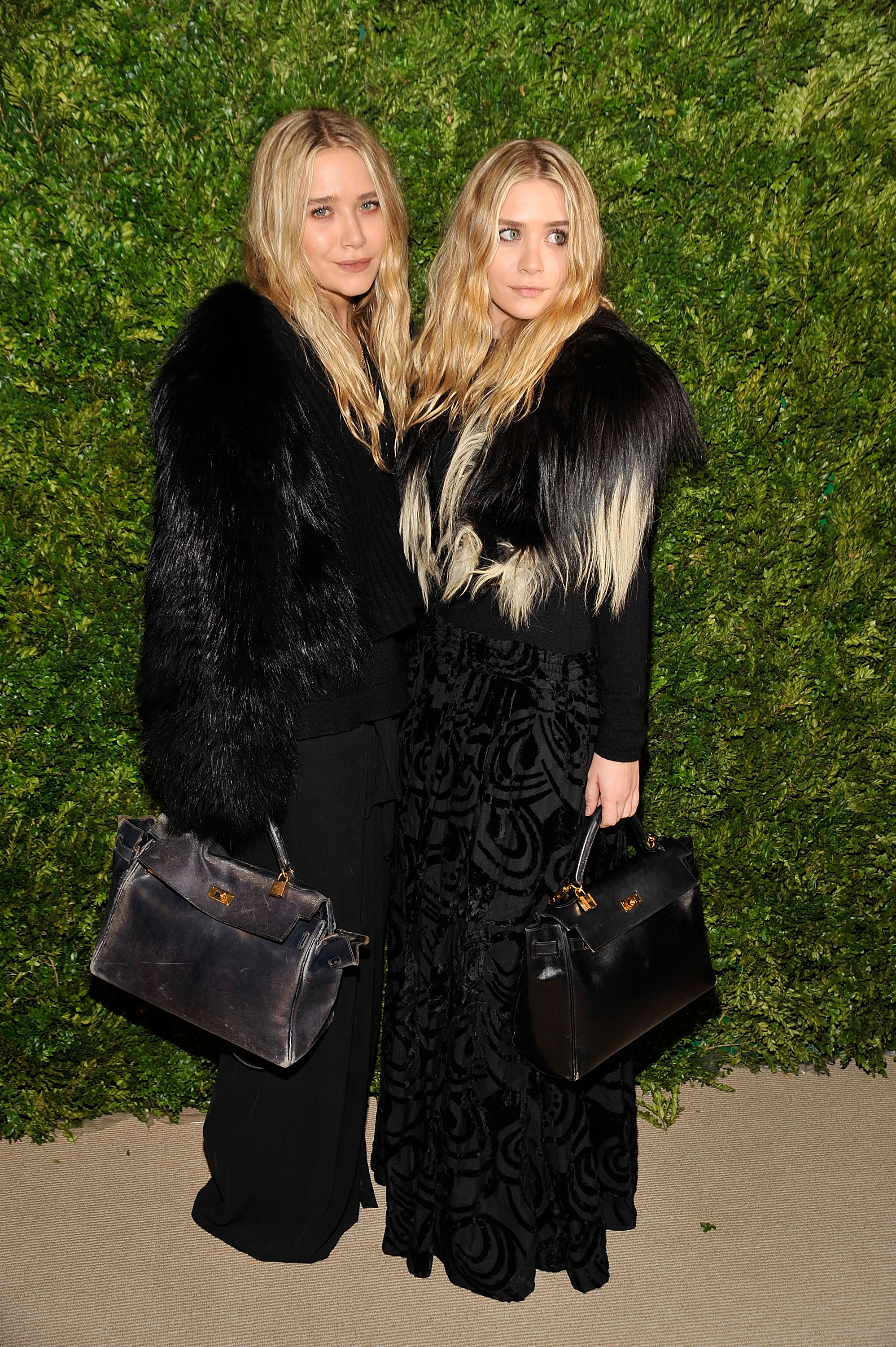 Ashley Olsen and Mary-Kate Olsen with their Kelly bags at the 7th Annual CFDA/Vogue Fashion Fund Awards at Skylight SOHO in New York City on November 15, 2010.