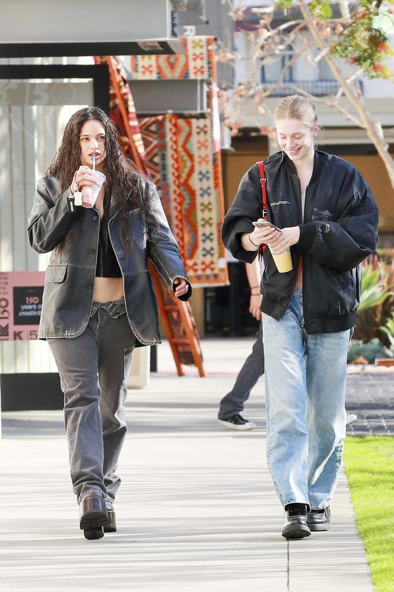 Singer Rosalia & actress Hunter Schafer seen drinking Erewhon smoothies & wearing matching outfits in Los Angeles