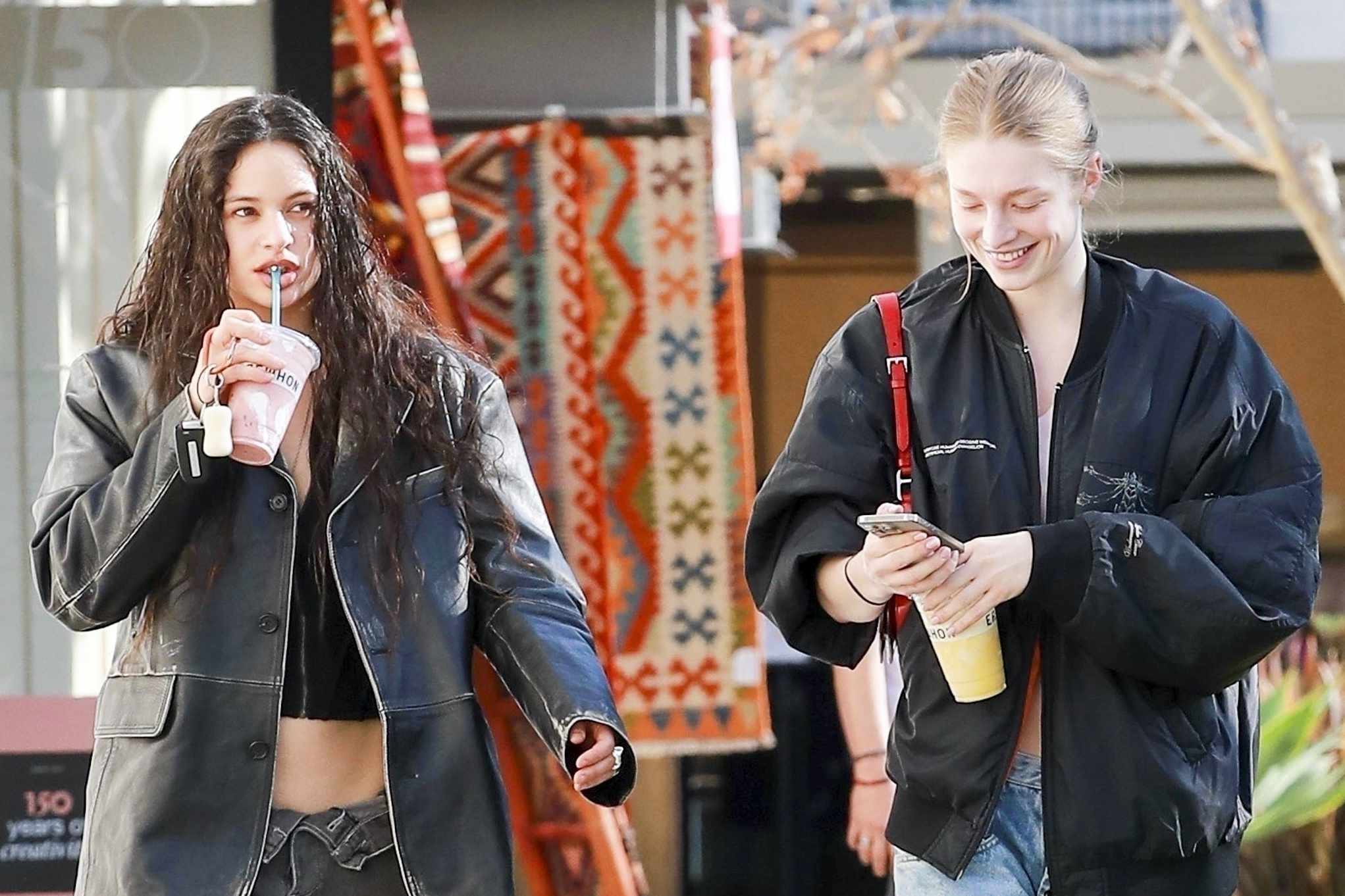Singer Rosalia & actress Hunter Schafer seen drinking Erewhon smoothies & wearing matching outfits in Los Angeles