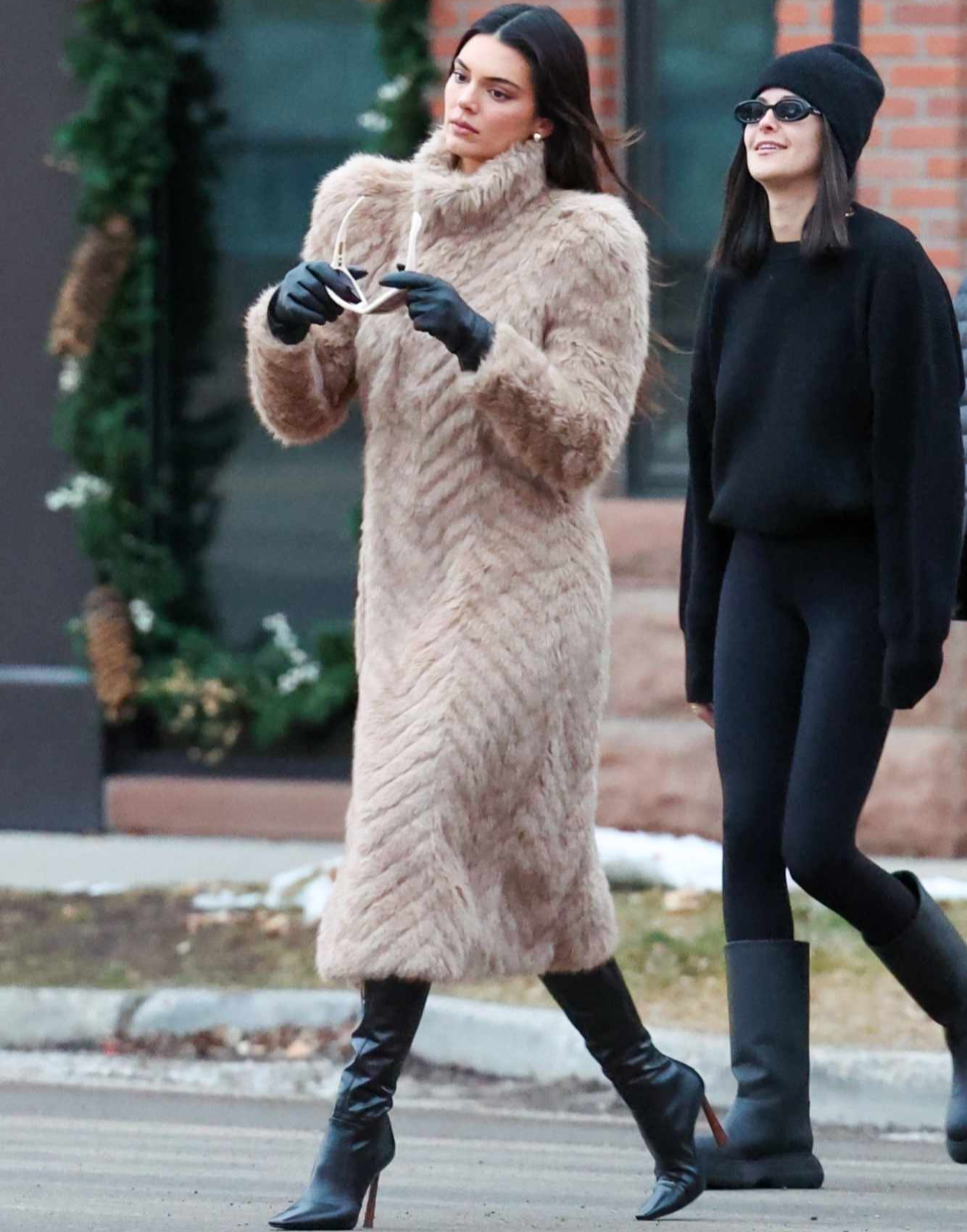 Kendall Jenner wears a Balenciaga fur coat, GIA BORGHINI boots & MEGA earrings in Aspen