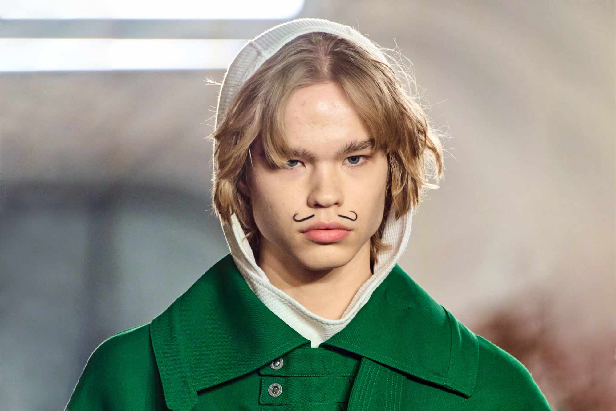 A model wears a green Kiko Kostadinov coat