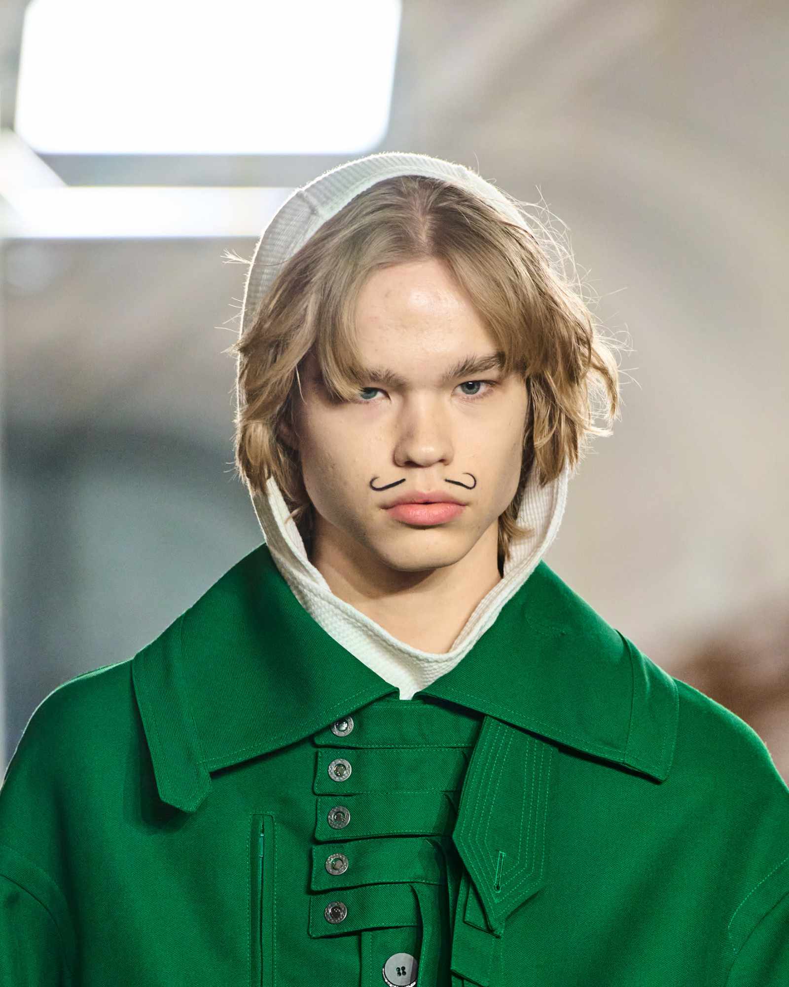 A model wears a green Kiko Kostadinov coat