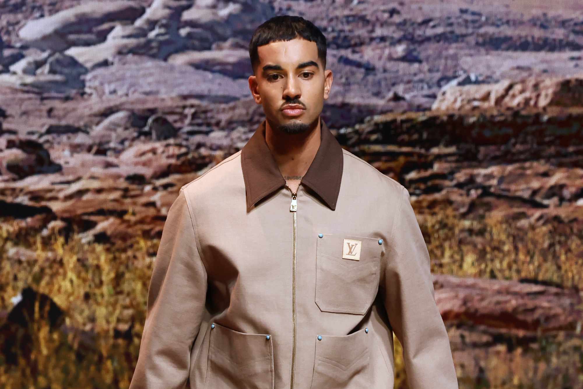 A model wears a Louis Vuitton menswear Carhartt-inspired jacket
