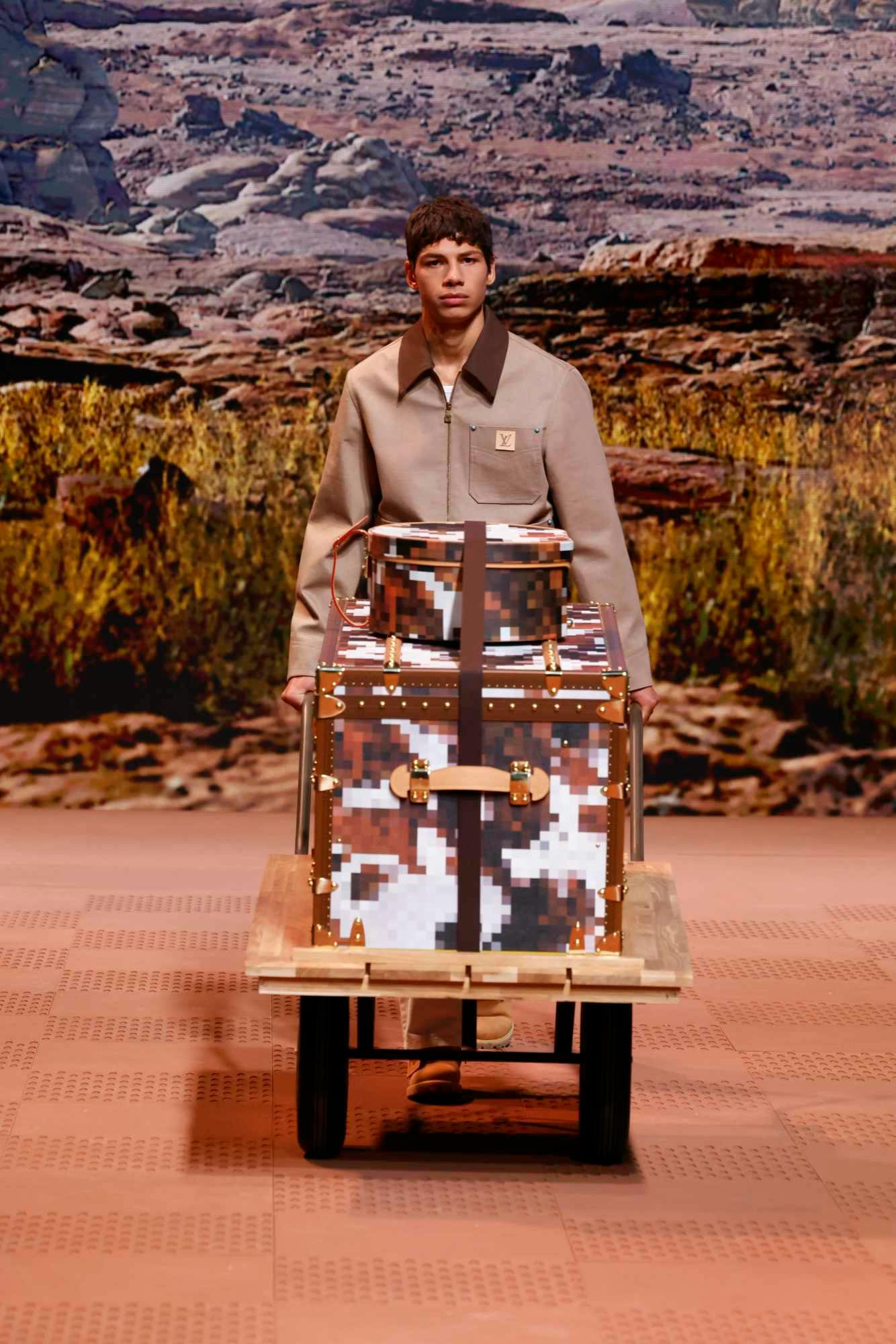 A model wears a Louis Vuitton menswear Carhartt-inspired jacket