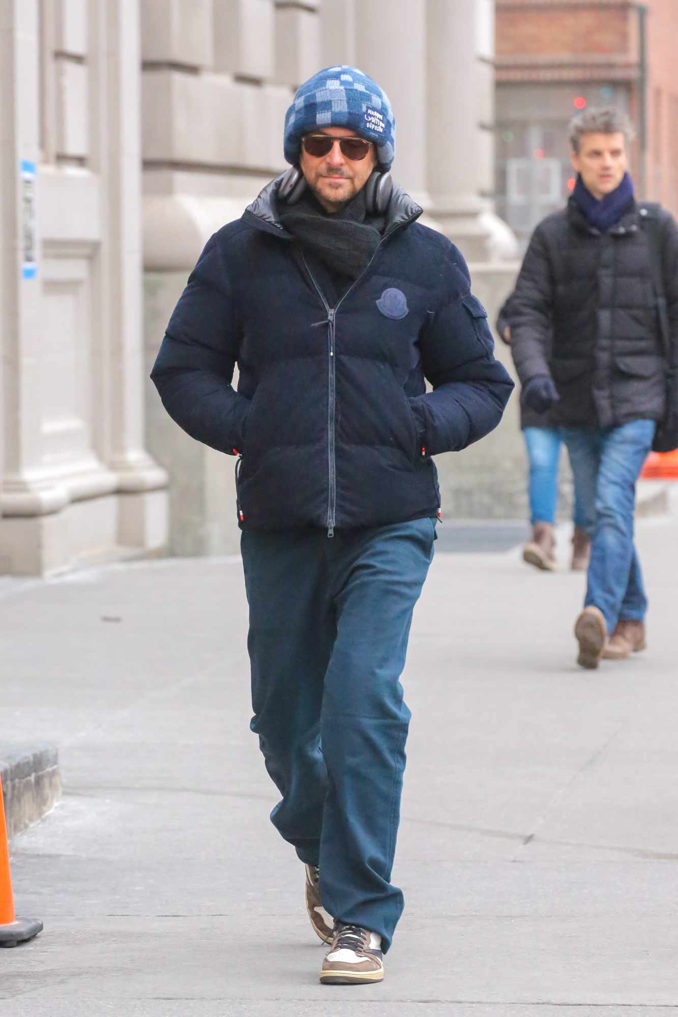 Bradley Cooper wears a Louis Vuitton beanie & Moncler jacket with Jordan sneakers in New York
