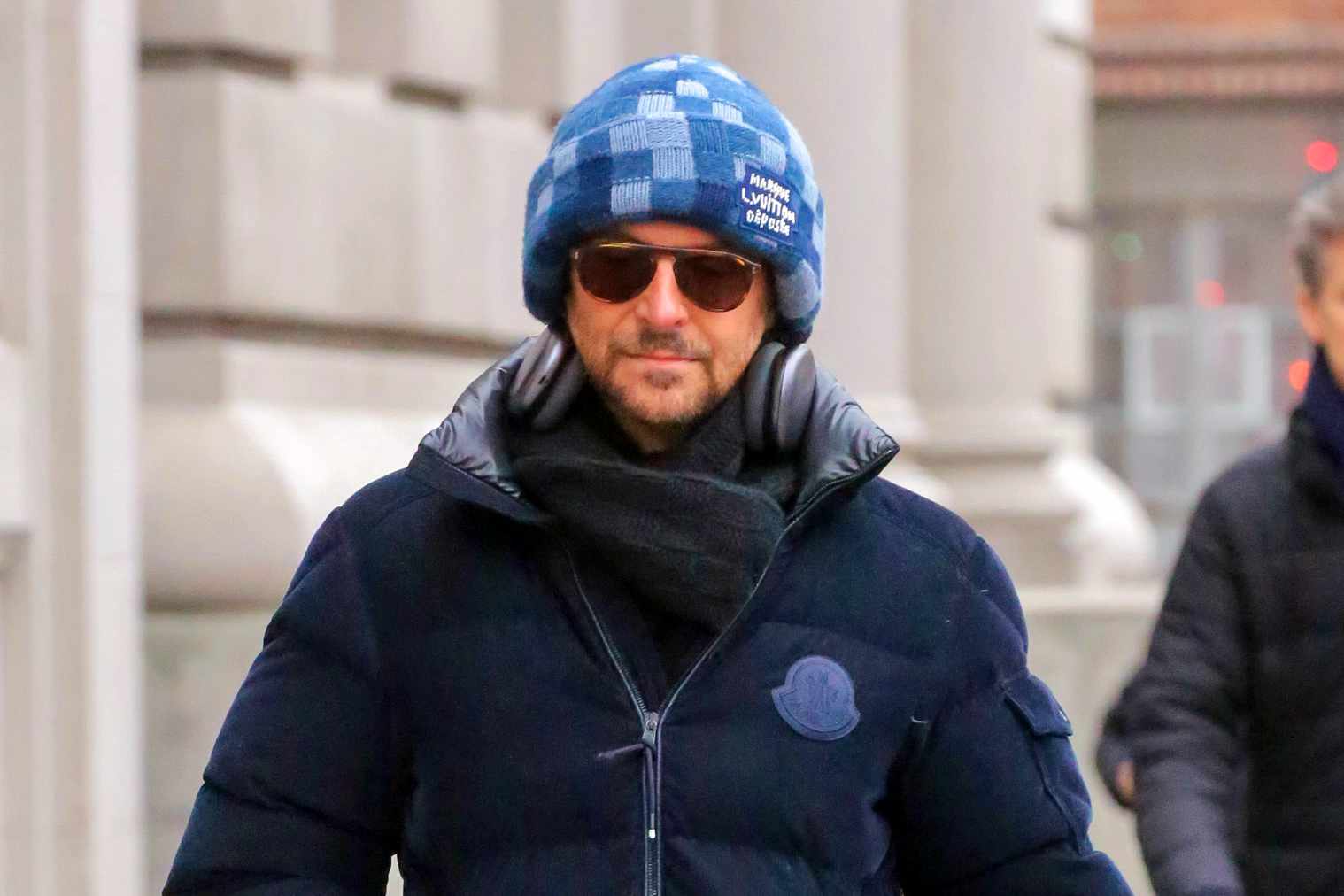 Bradley Cooper wears a Louis Vuitton beanie & Moncler jacket with Jordan sneakers in New York