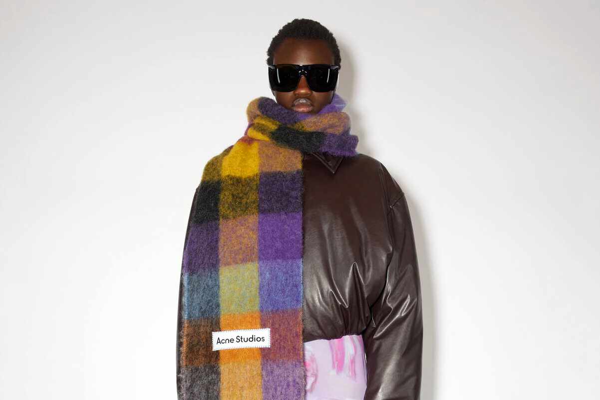 A model wears Acne Studios' scarf in mohair check