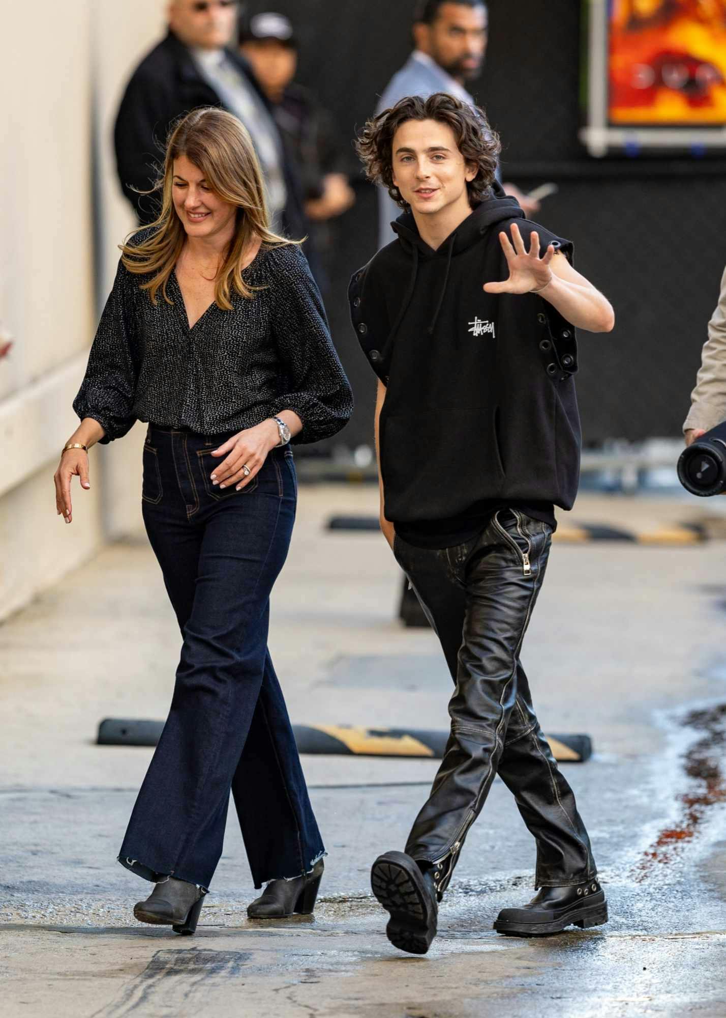 Timothee Chalamet wears a black Stüssy x Junya Watanabe sleeveless hoodie, leather pants, black boots