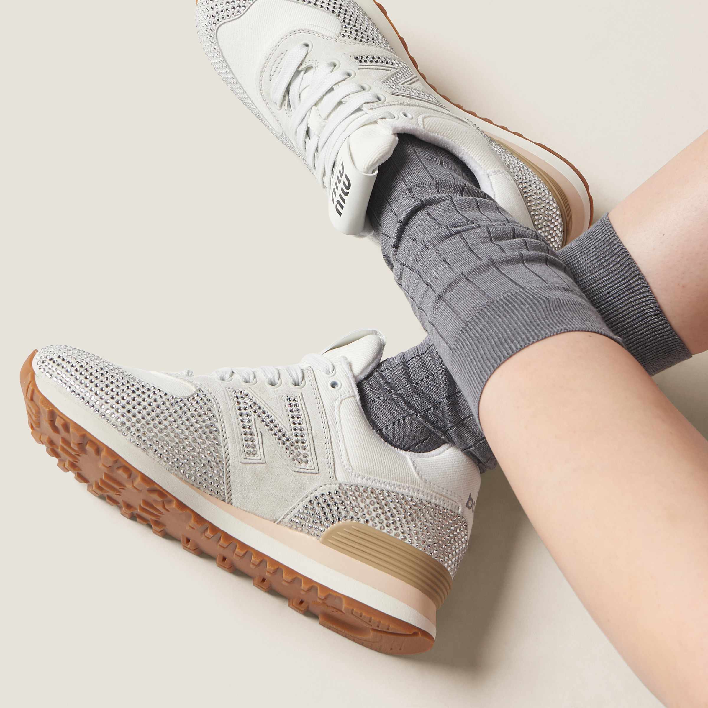 Miu Miu's New Balance 574 sneaker in white suede & denim with crystals