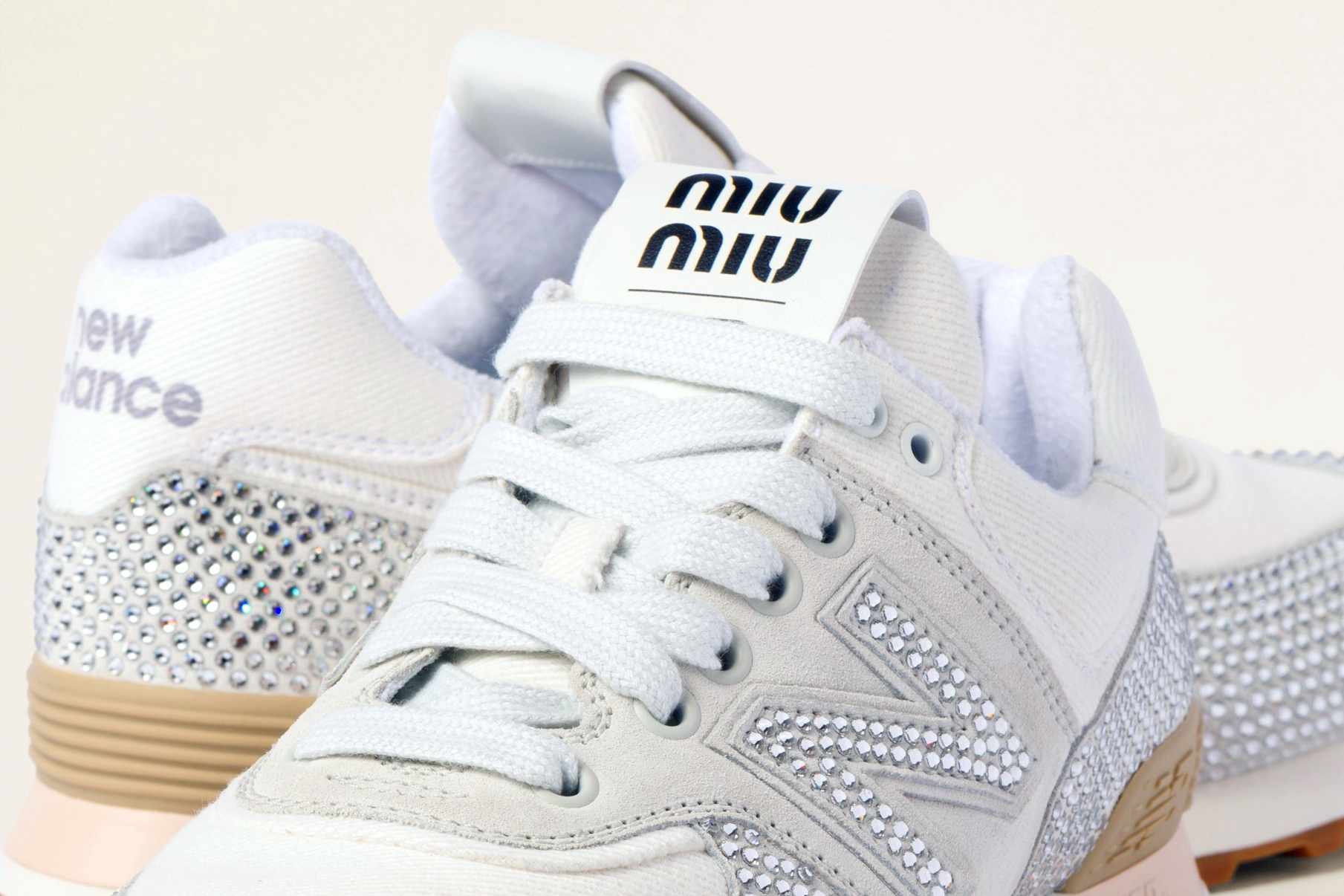 Miu Miu's New Balance 574 sneaker in white suede & denim with crystals
