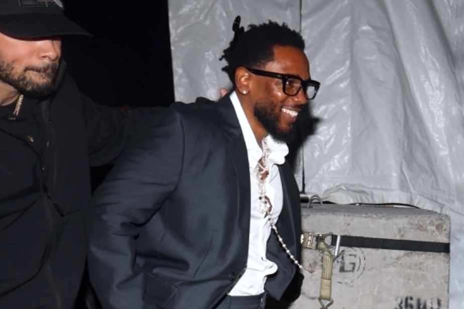 Kendrick Lamar wears a black suit, white shirt, and yellow sneakers at Cash App's Super Bowl 2024 party