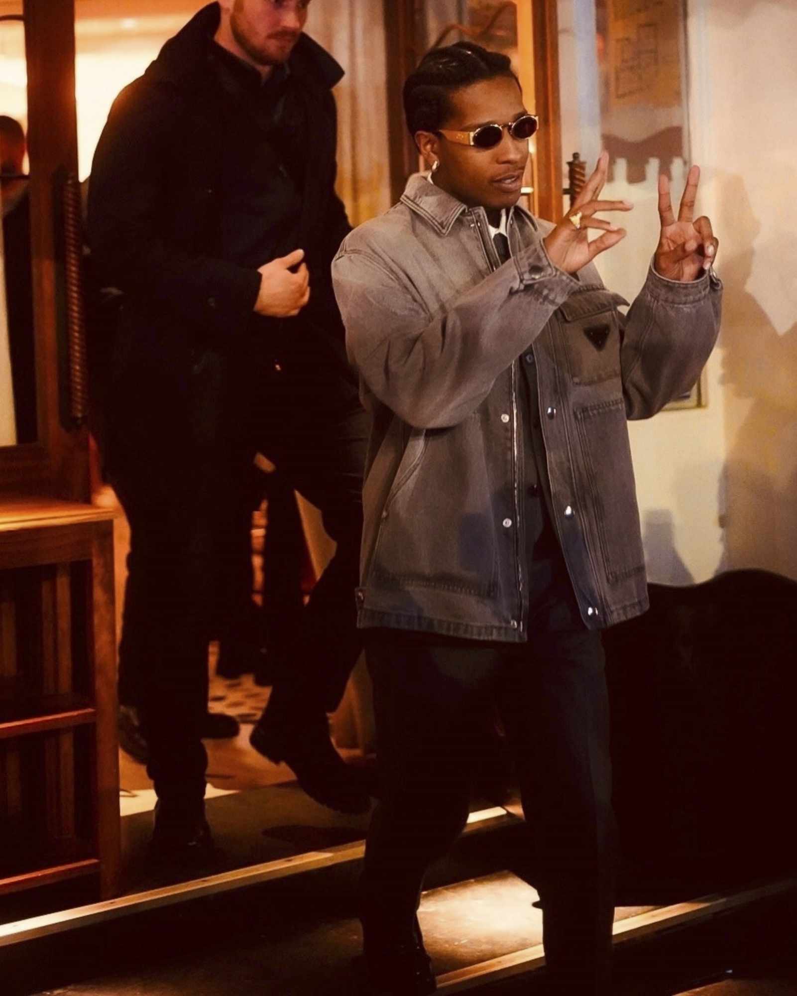A$AP Rocky poses in Paris wearing sunglasses and a Prada denim jacket