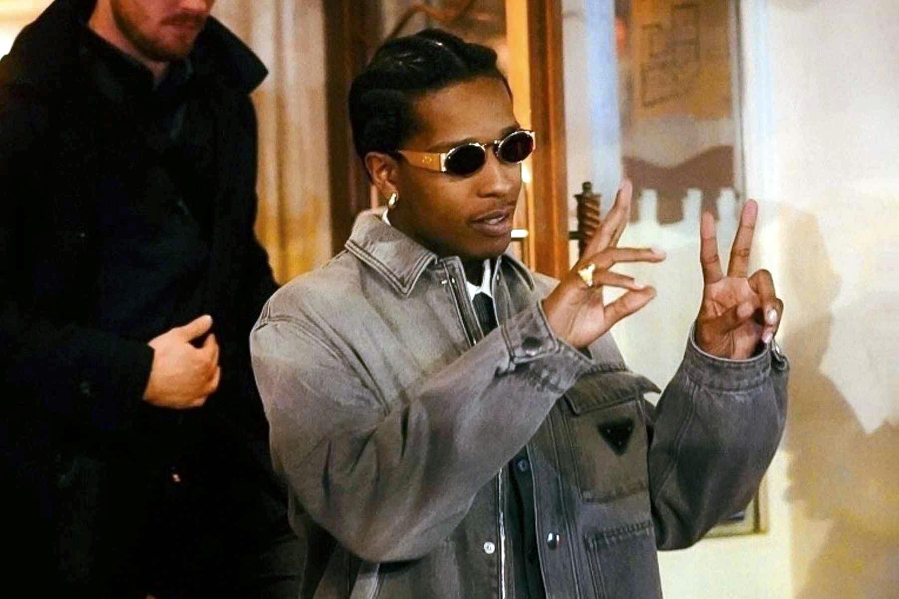 A$AP Rocky poses in Paris wearing sunglasses and a Prada denim jacket