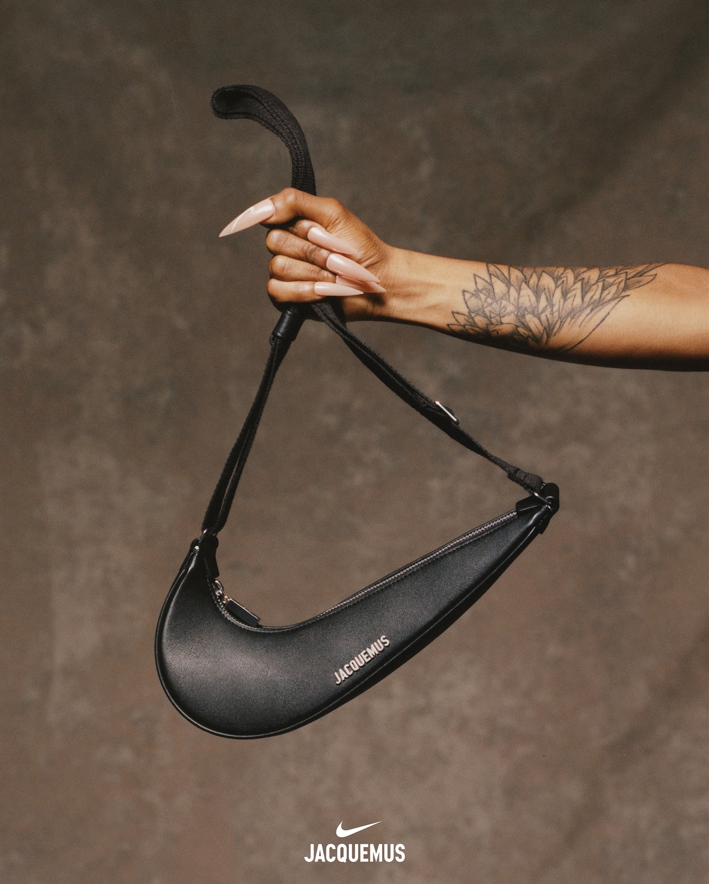 Sha'Carri Richardson holding Jacquemus' black leather Nike Swoosh handbag