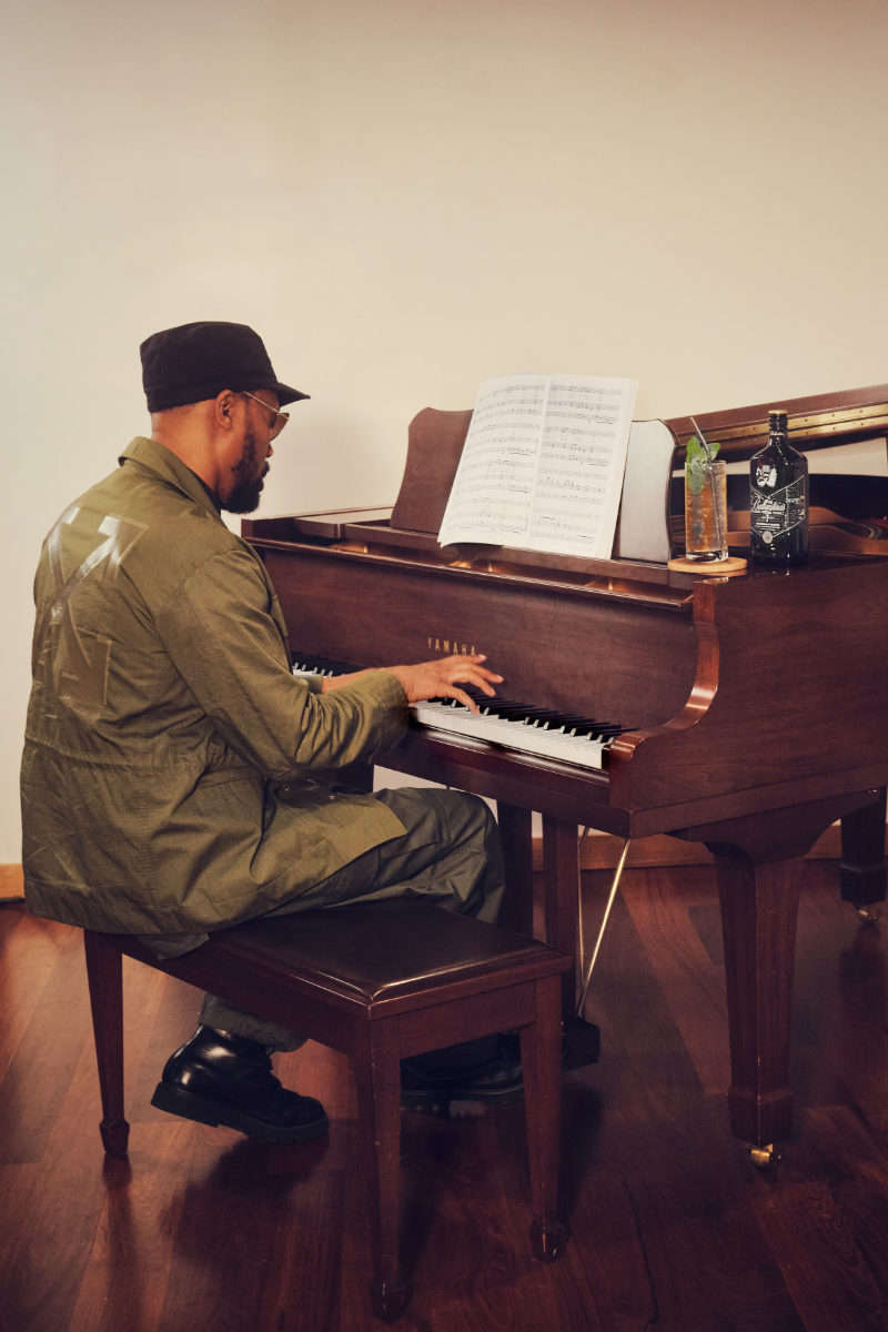 RZA playing the piano with Ballantine's bottle on top of piano