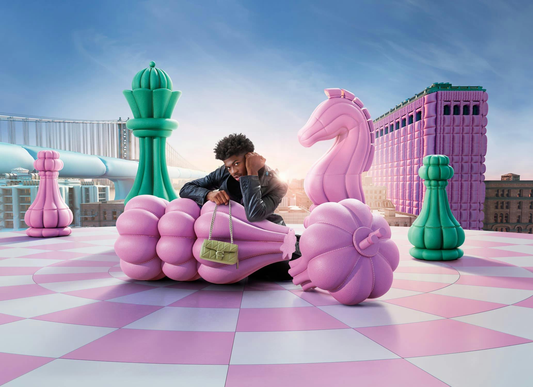 Lil Nas X holding Coach handbag in a pastel fantasy world