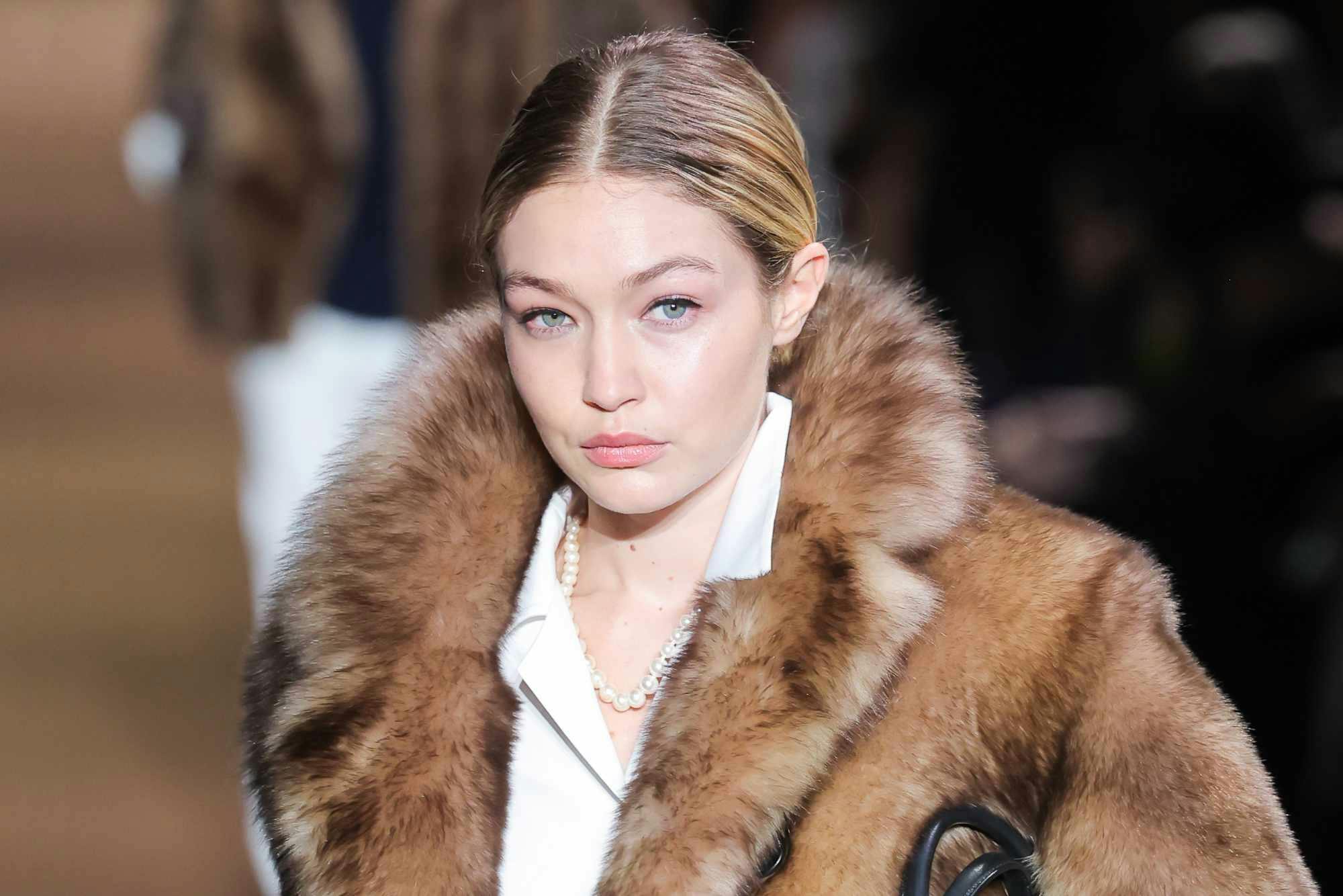 Gigi Hadid wearing a fur coat at the Miu Miu FW24 runway show