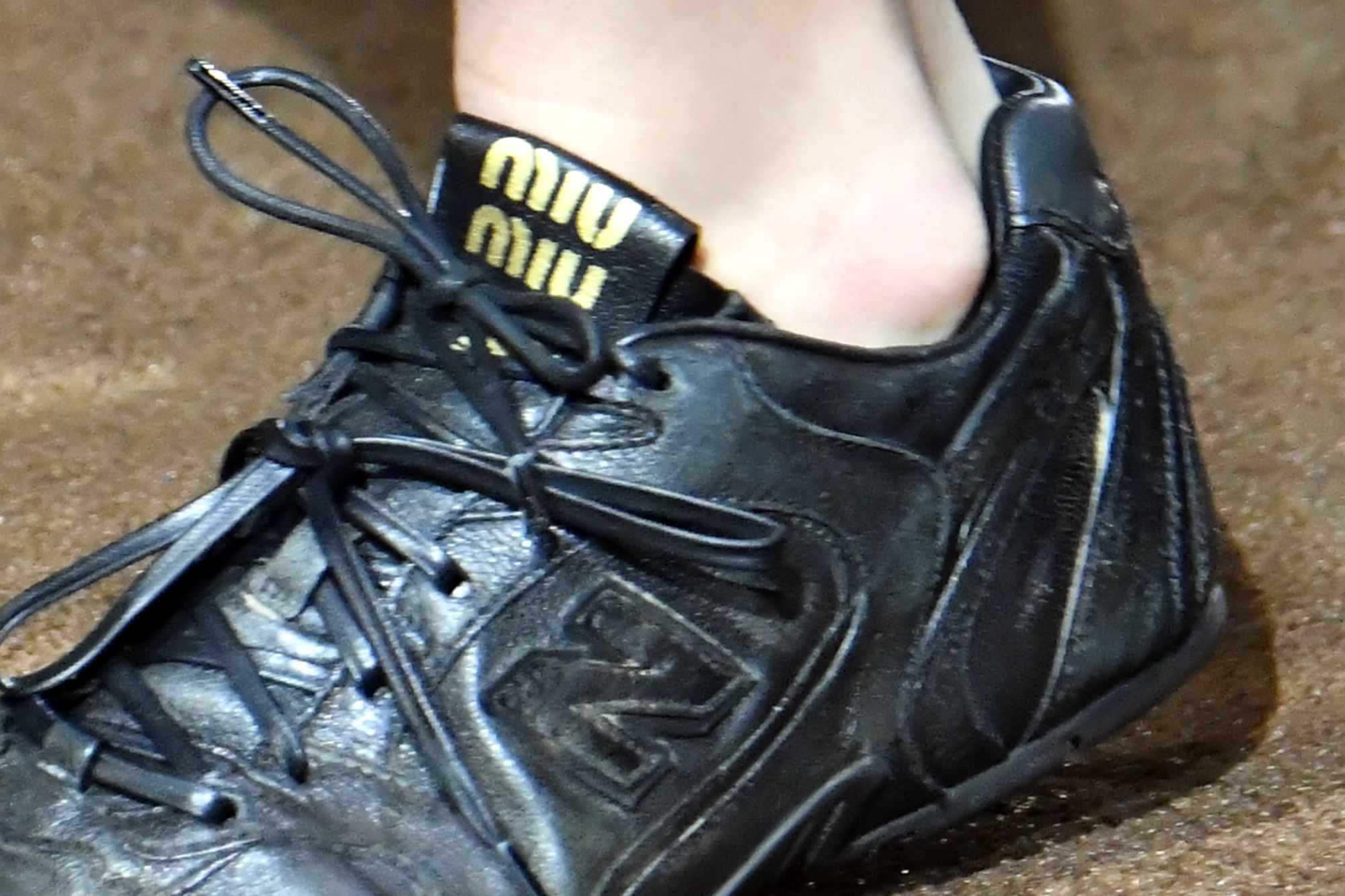 Miu Miu's black New Balance 530 sneaker with a flat sole