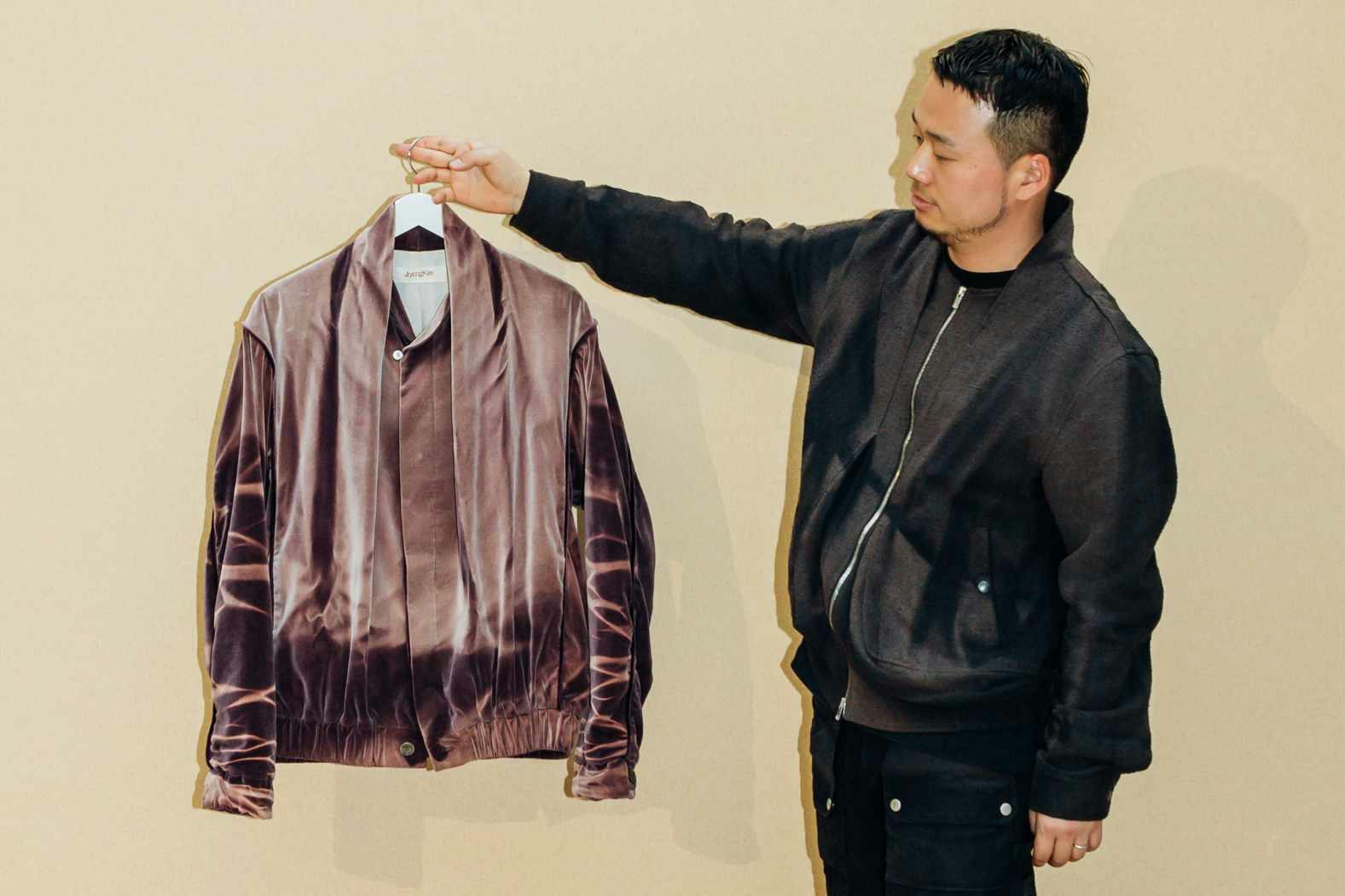 Designer JiyongKim seen holding his clothes at the 2024 LVMH Prize