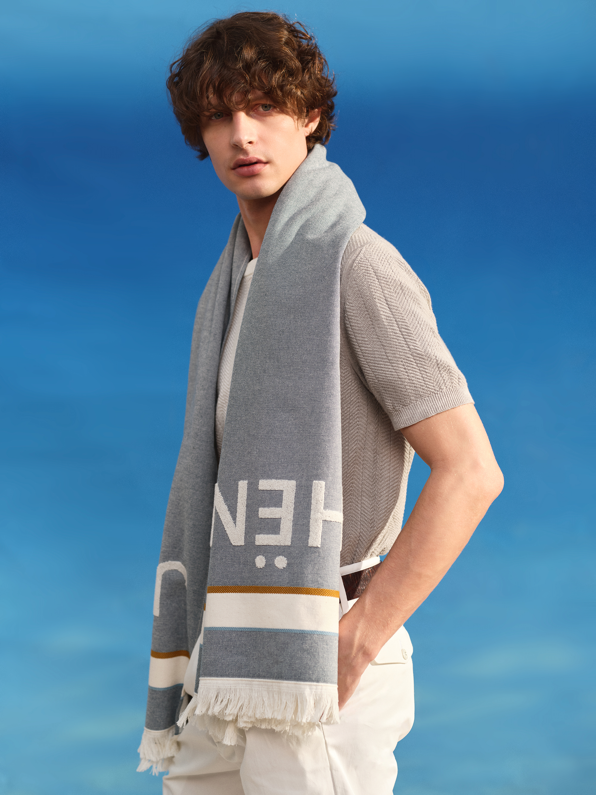 Model with Jacob Cohën beach towel around neck