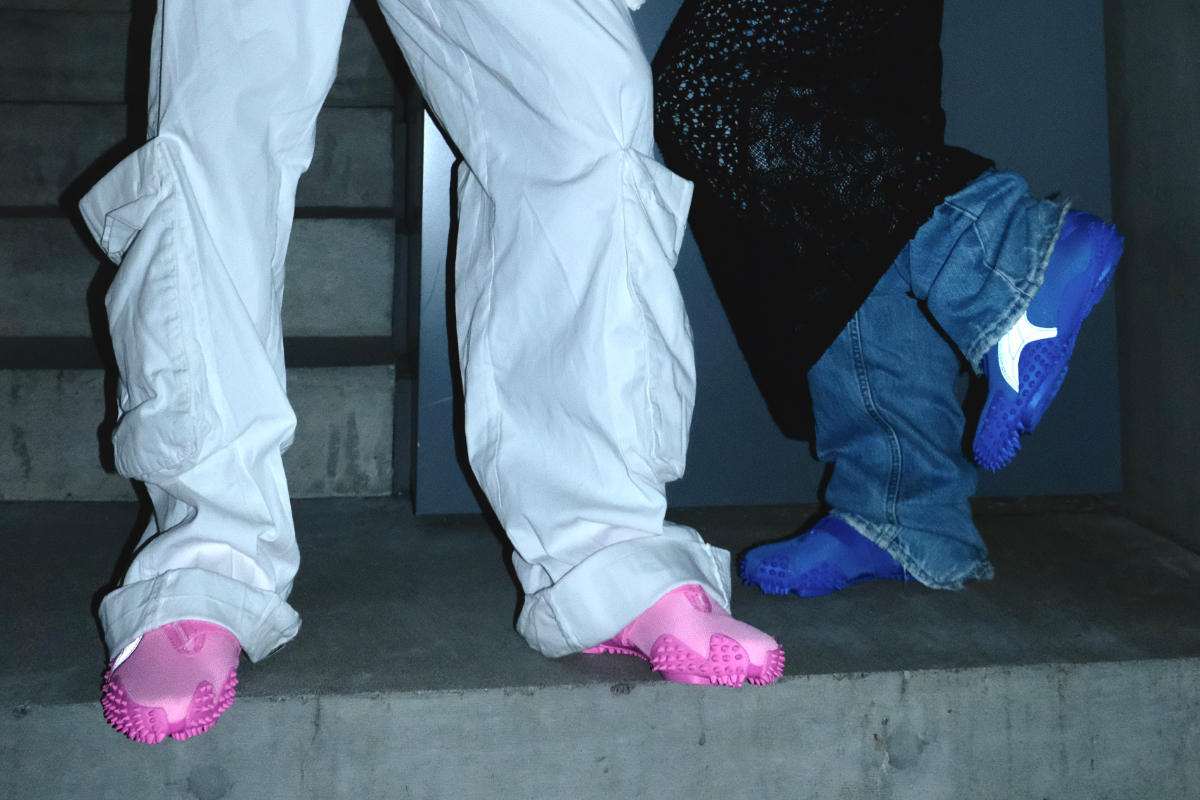 Close-up of two people wearing PUMA shoes in blue and pink