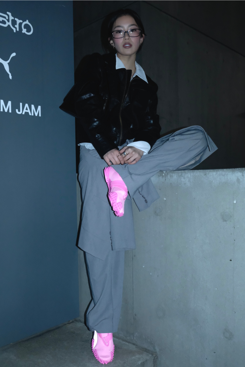 Woman wearing pink PUMA Mostro shoes at the launch event