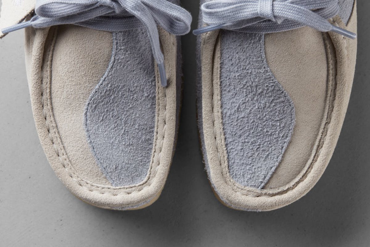 Close-up of the front of two moccasin-style shoes with a yin-yang pattern on the upper