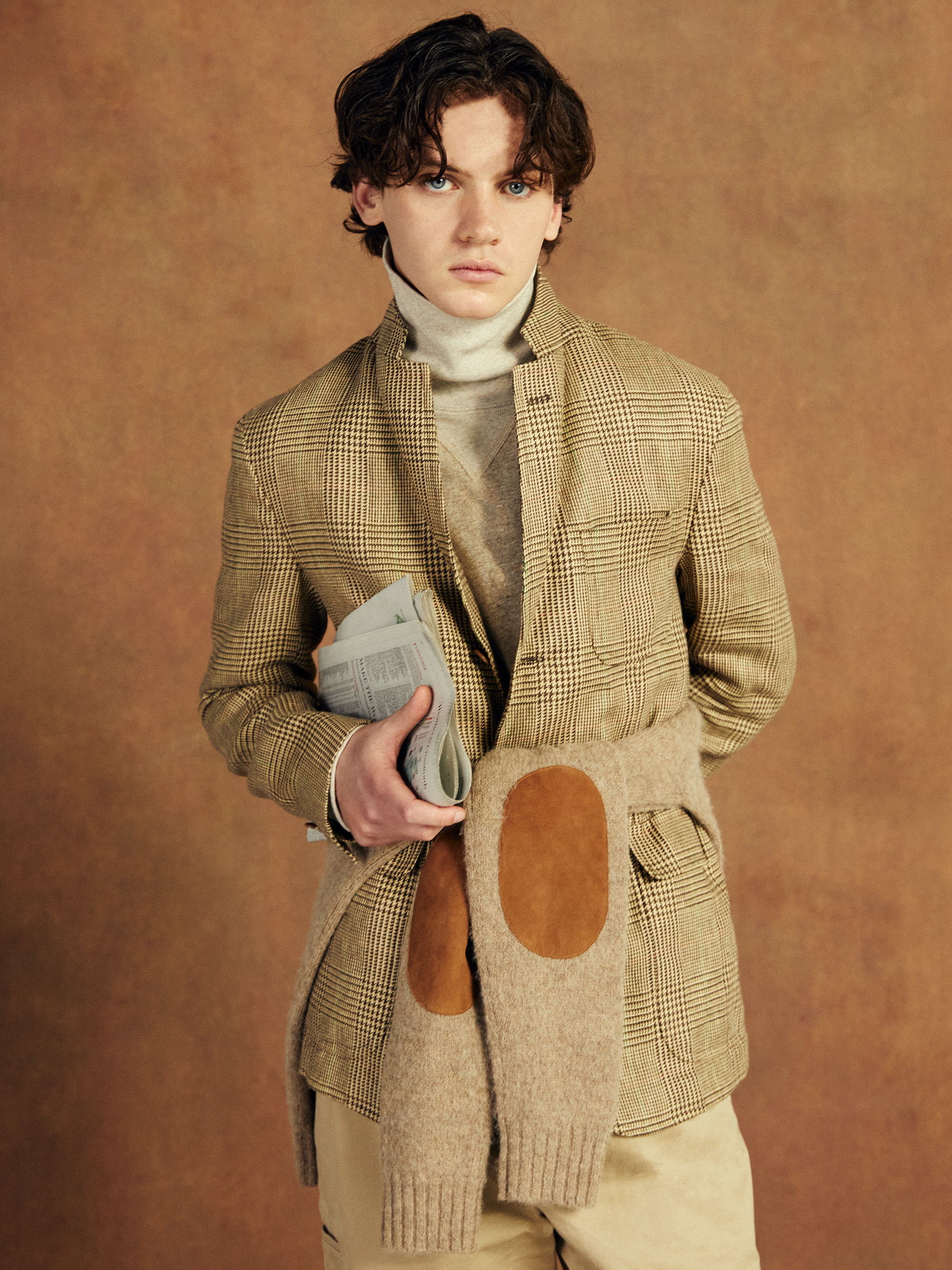 Model poses in a timeless tweed suit