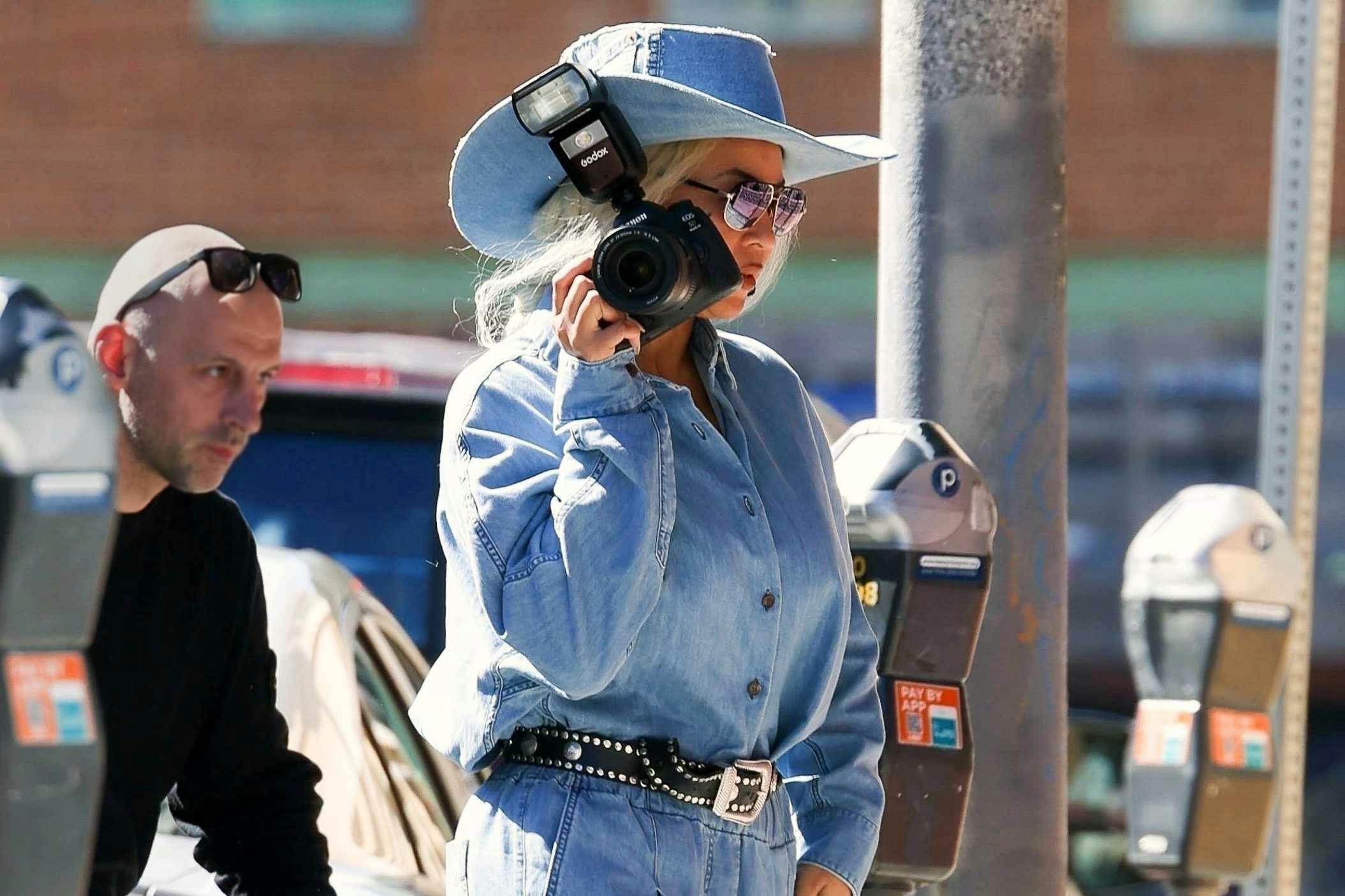 Beyonce wears a blue denim suit, cowboy hat and grey boots with a black belt