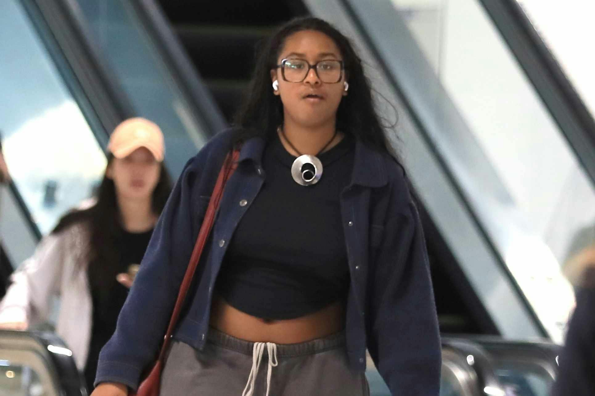 Sasha Obama at LAX wearing greay shirts, sweatpants, hoodies, and a silver necklace