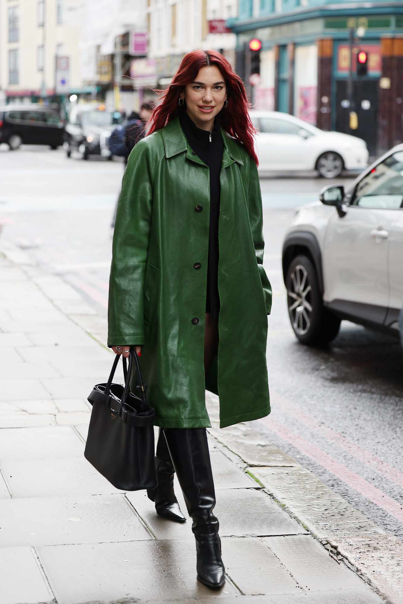 Dua Lipa wears a green Ferragamo coat in London to promote new album Radical Optimism