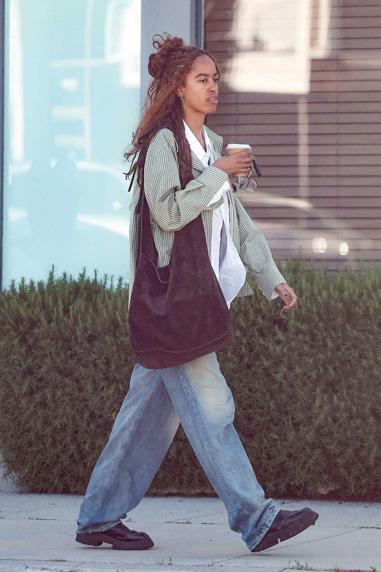 Malia Obama seen in Los Angeles attending an acting class with a striped shirt, white shirt, blue jeans, and black shoes