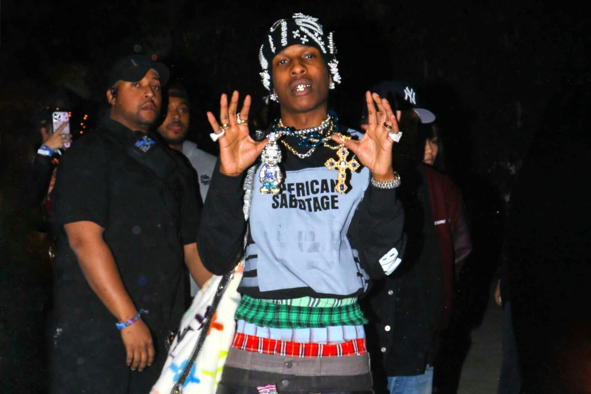 ASAP Rocky wears pearl hat, American Sabotage shirt, four-layered underwear pants, and beige Bottega Veneta boots