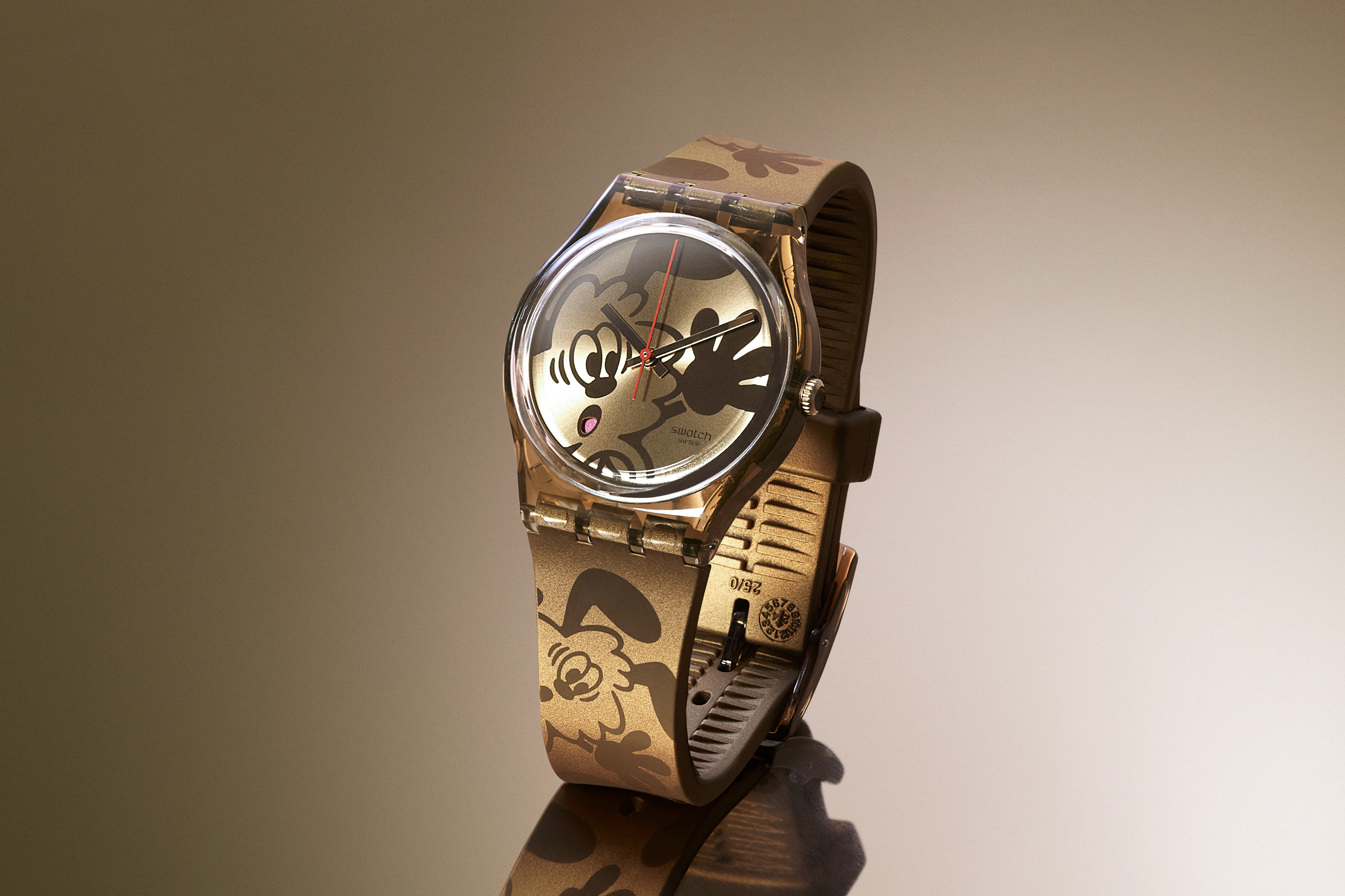 Bronze watch with pop art design against a gradient background