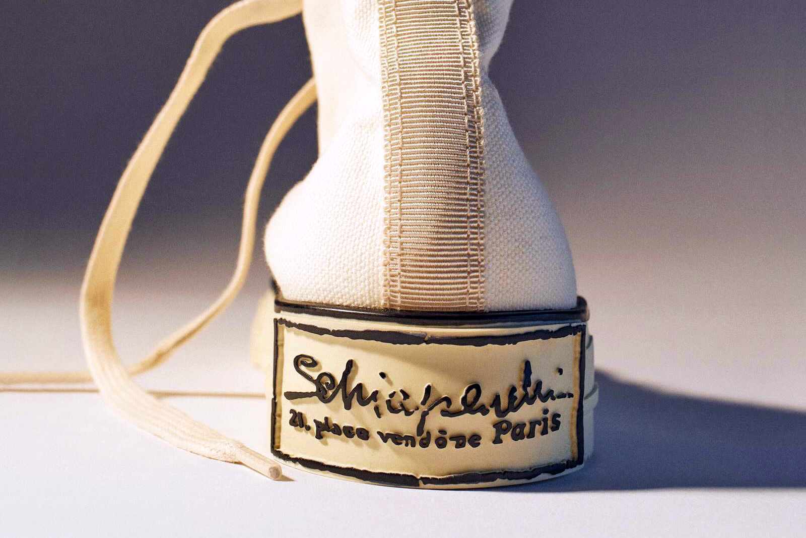Schiaparelli's Pour Le Sport gold trimmed sneaker