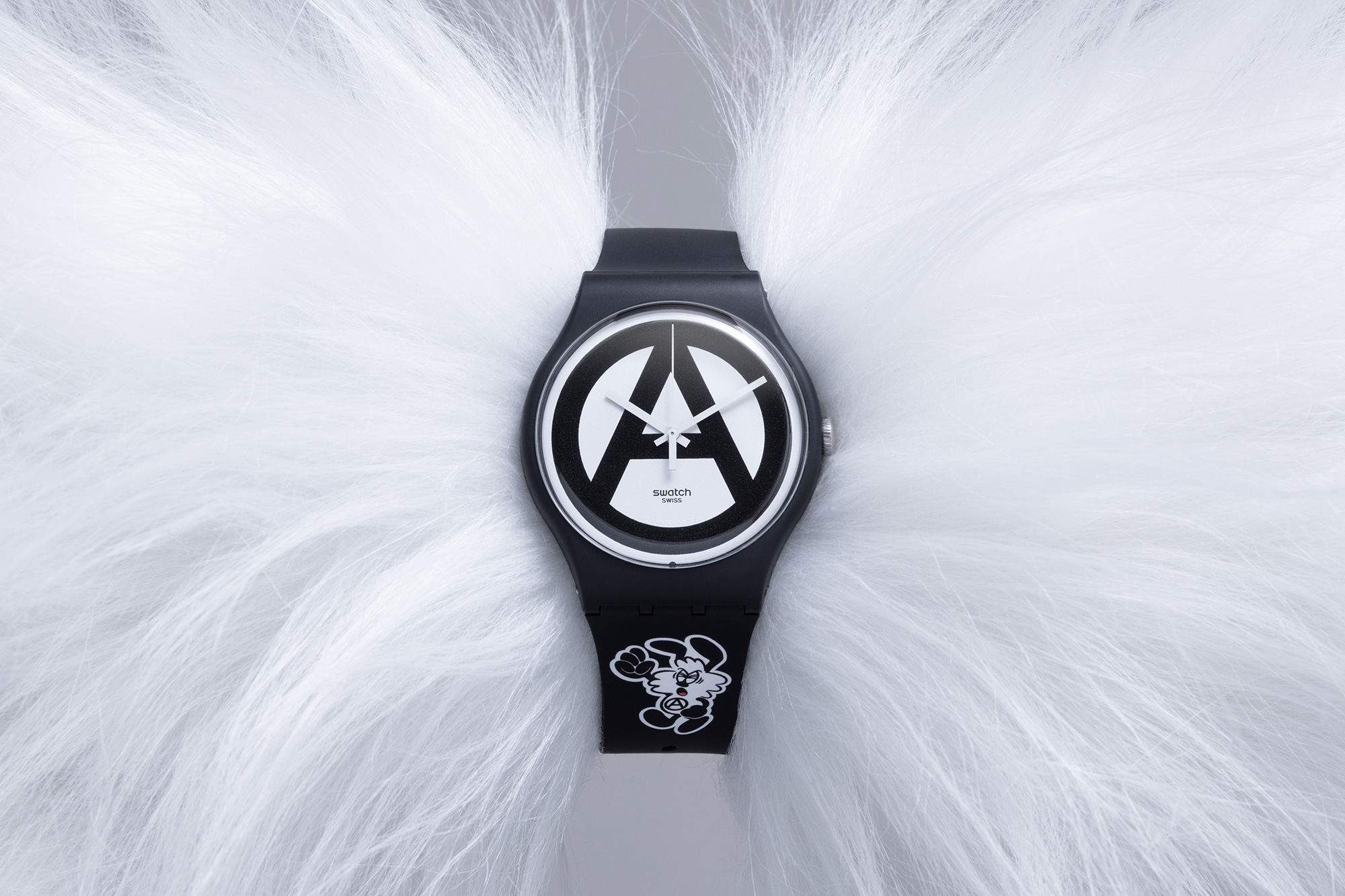 Product shot of black and white watch wrapped around white fluff