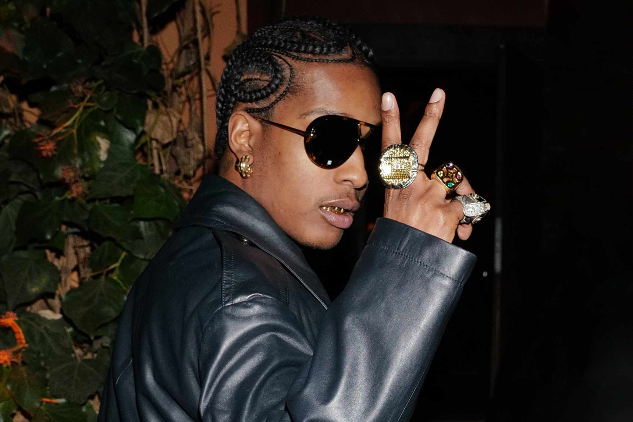 A$AP Rocky wears a black Bottega Veneta suit with dark sunglasses