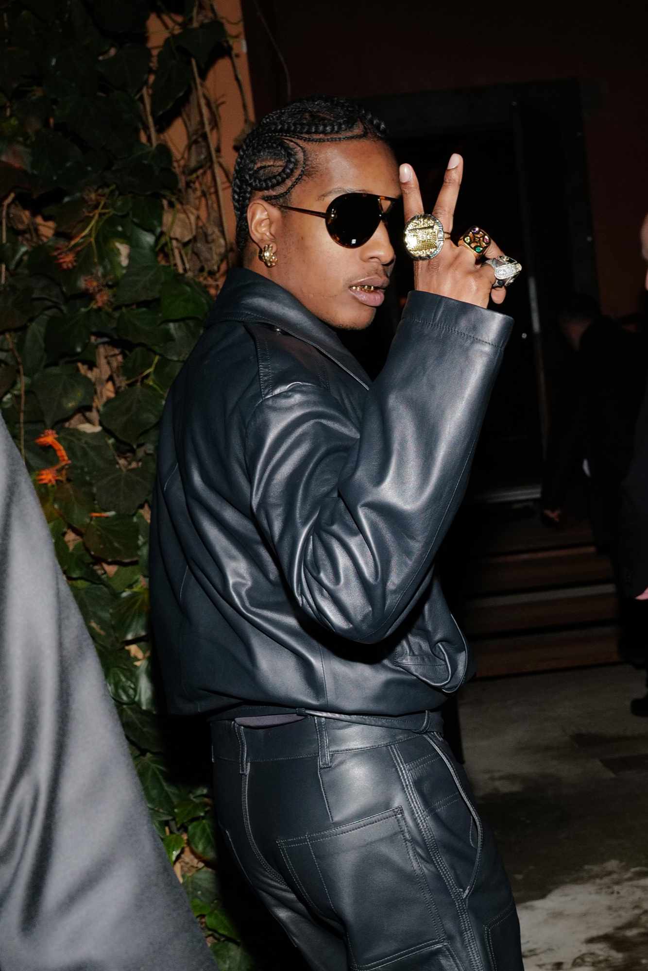 A$AP Rocky wears a black Bottega Veneta suit with dark sunglasses
